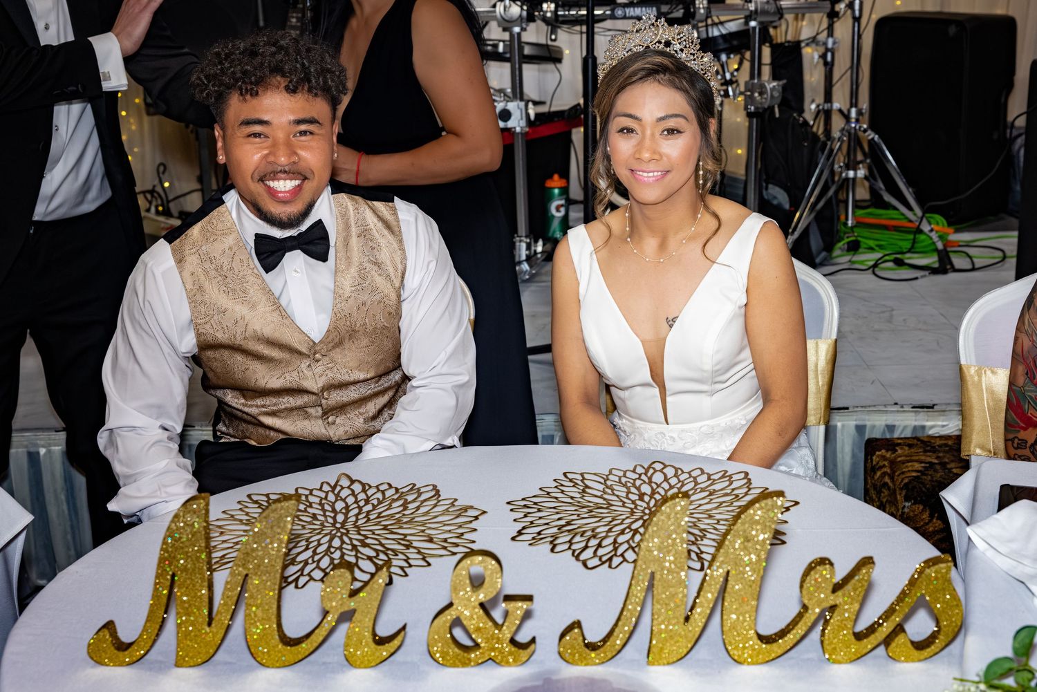 Wedding reception table decorated with a Mr & Mrs sign and elegant place settings.
