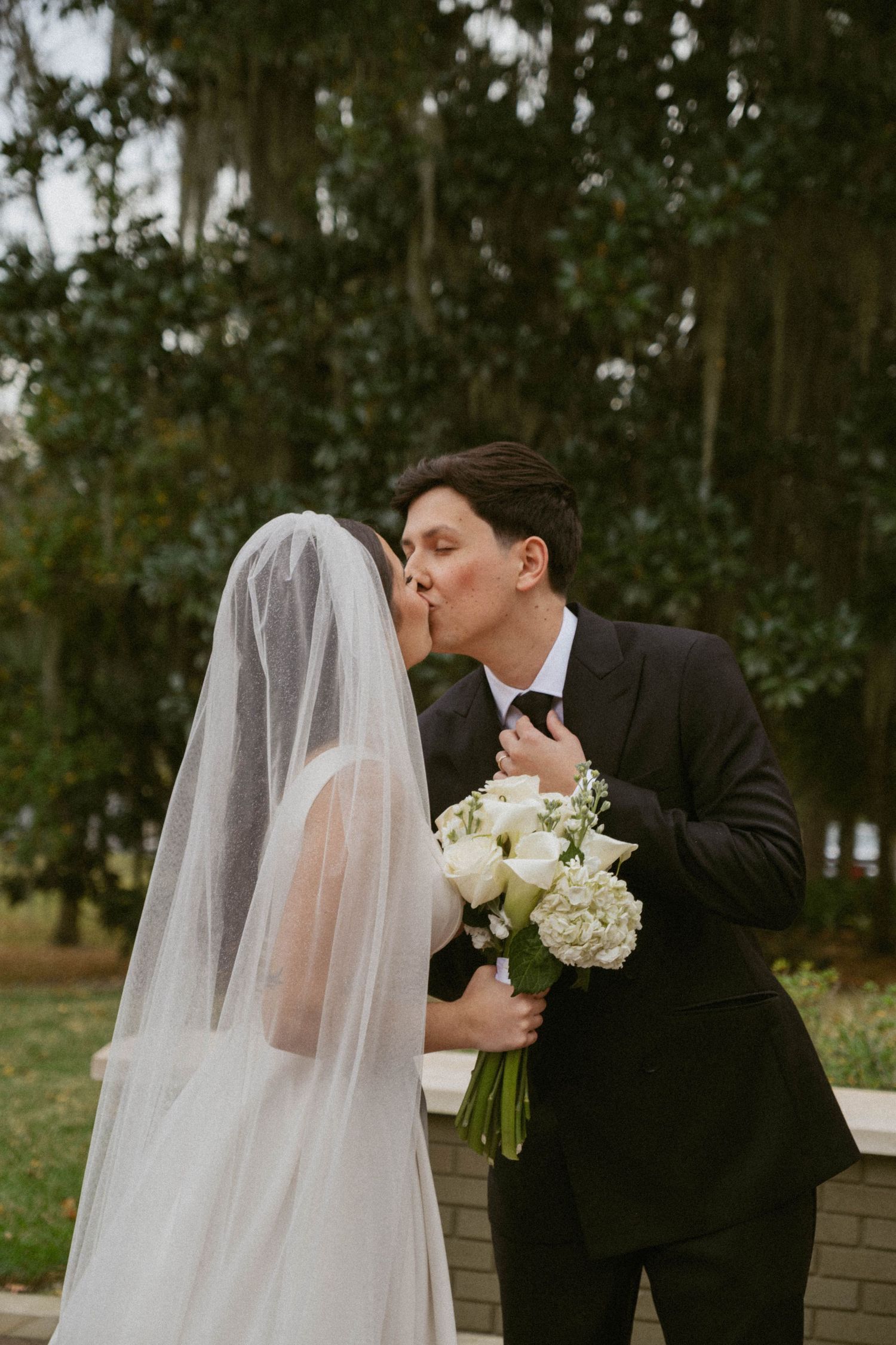 A romantic wedding moment captured in a sequence of photos showing a kiss between a bride in white and groom in black suit.