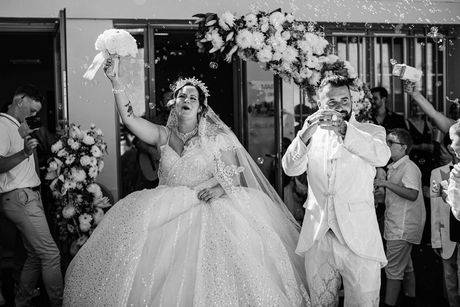A series of candid wedding celebration moments with guests dancing and enjoying festivities at an indoor reception.