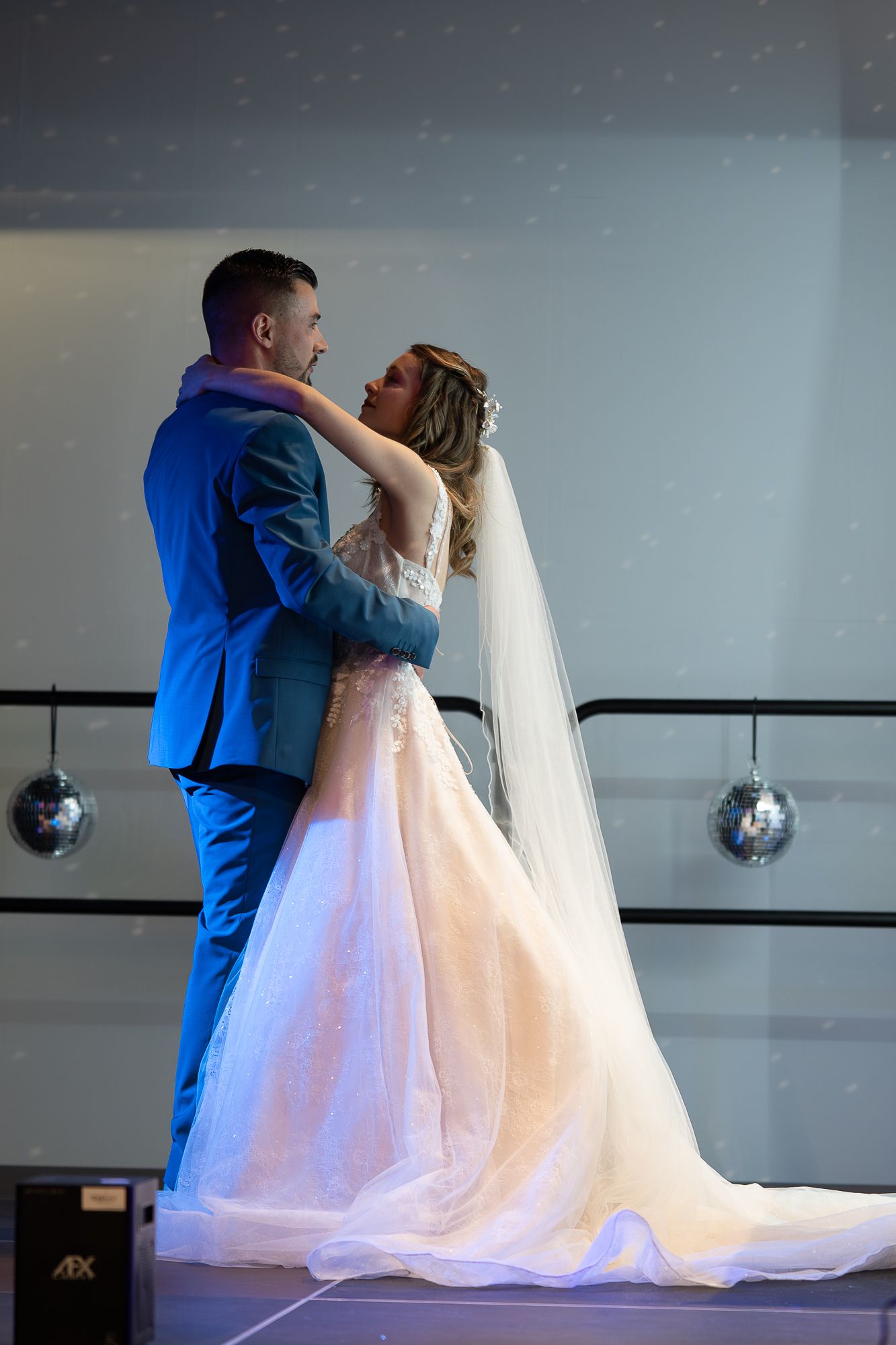 A sequence of romantic dance photos showing a couple in wedding attire under soft lighting.