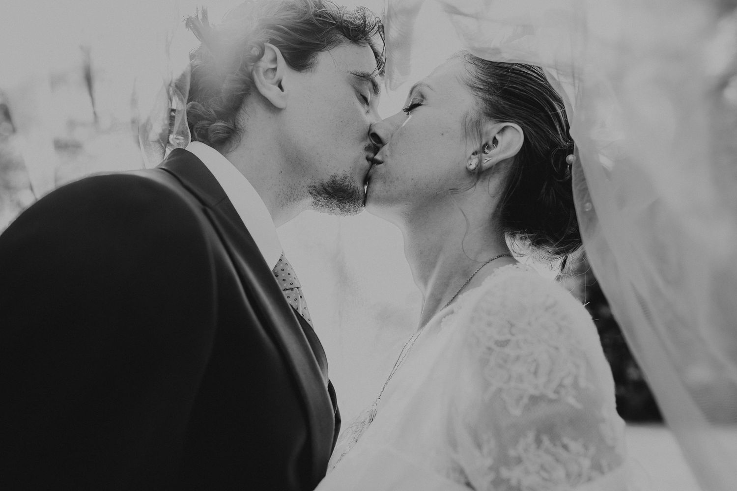 Black and white romantic wedding photo collage showing intimate moments between newlyweds in various poses.