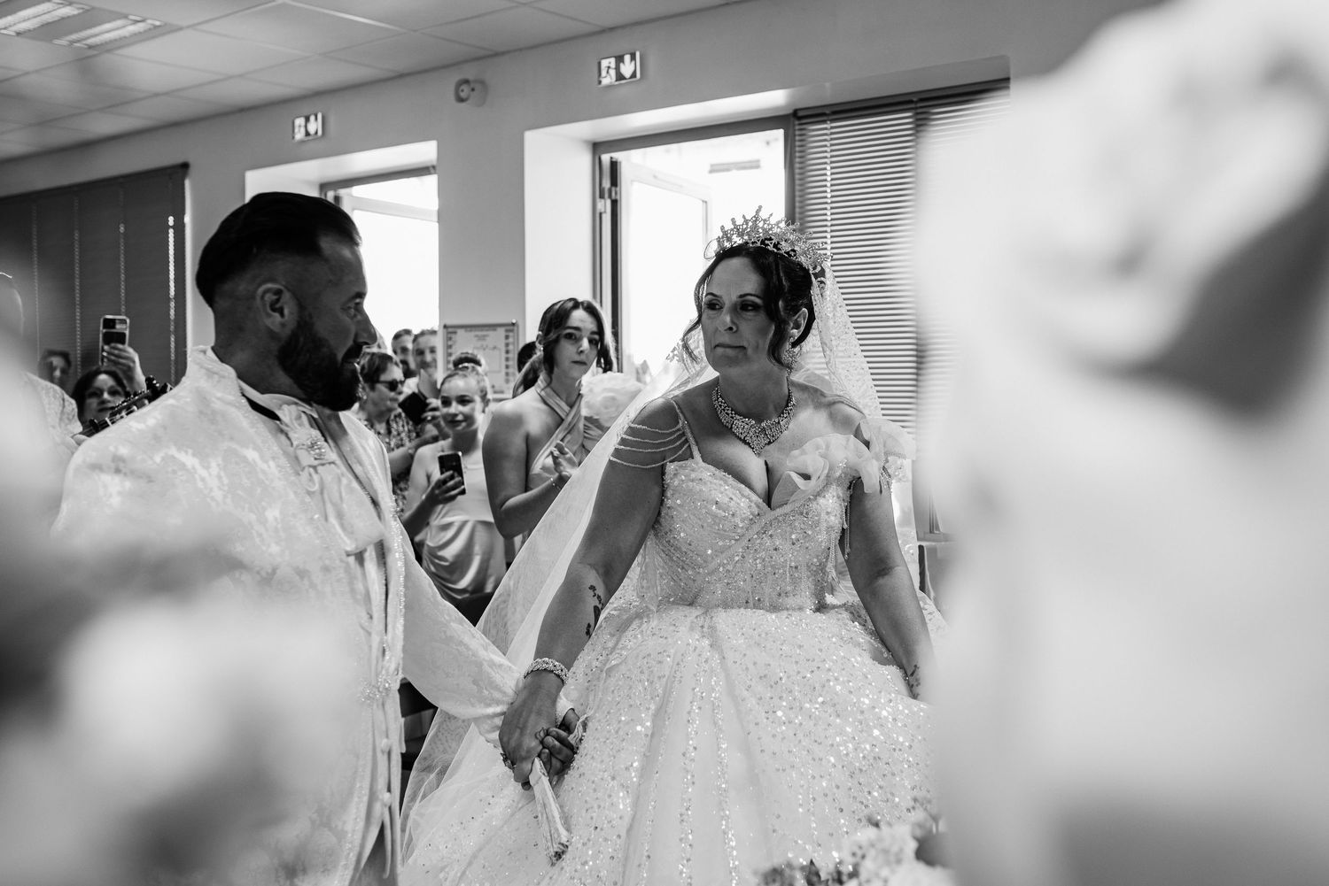 A sequence of black and white wedding photos showing emotional moments during a celebration.