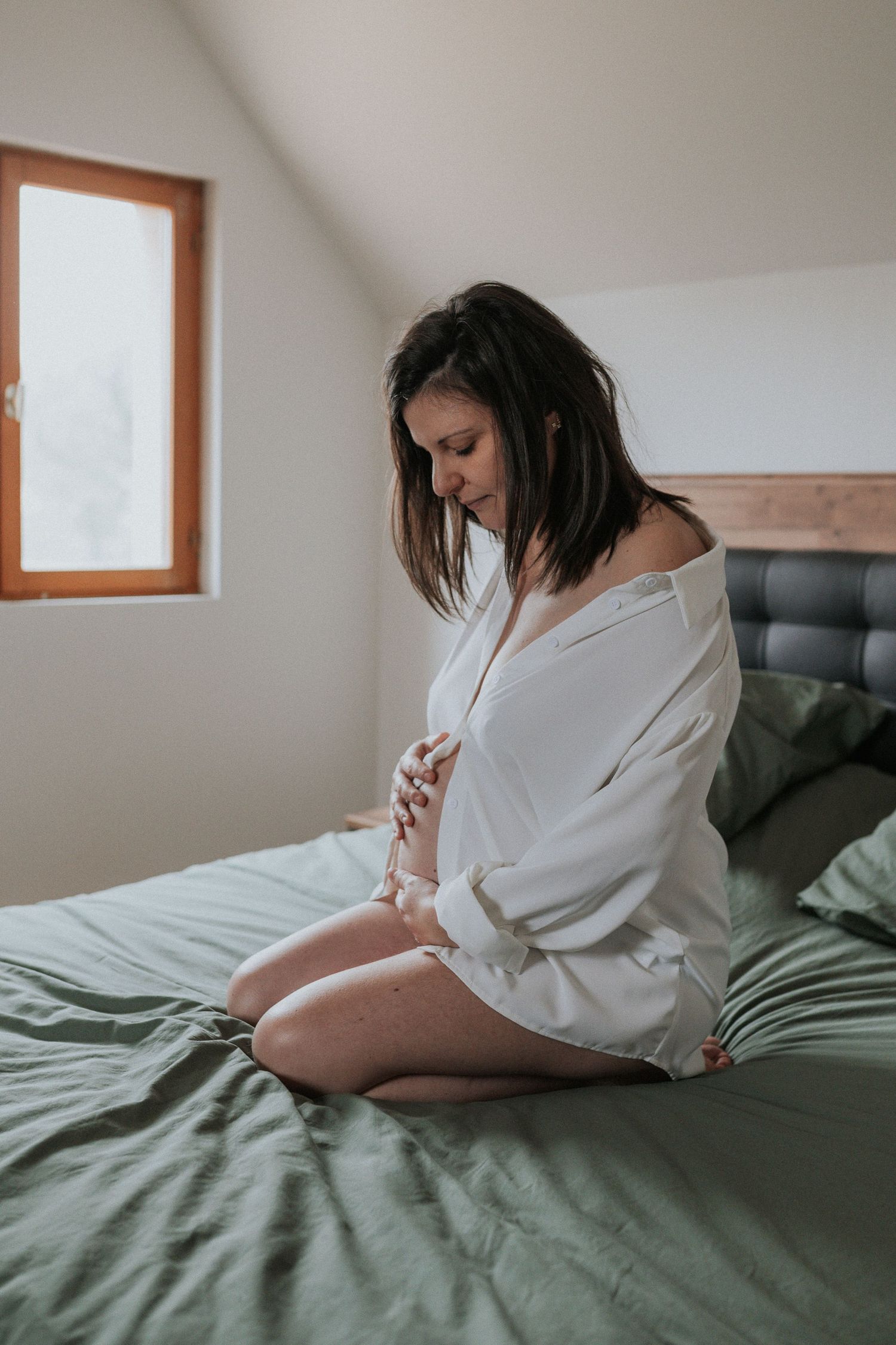 A series of intimate boudoir photos showing someone in a white sweater reclining on green bedding in soft natural light.
