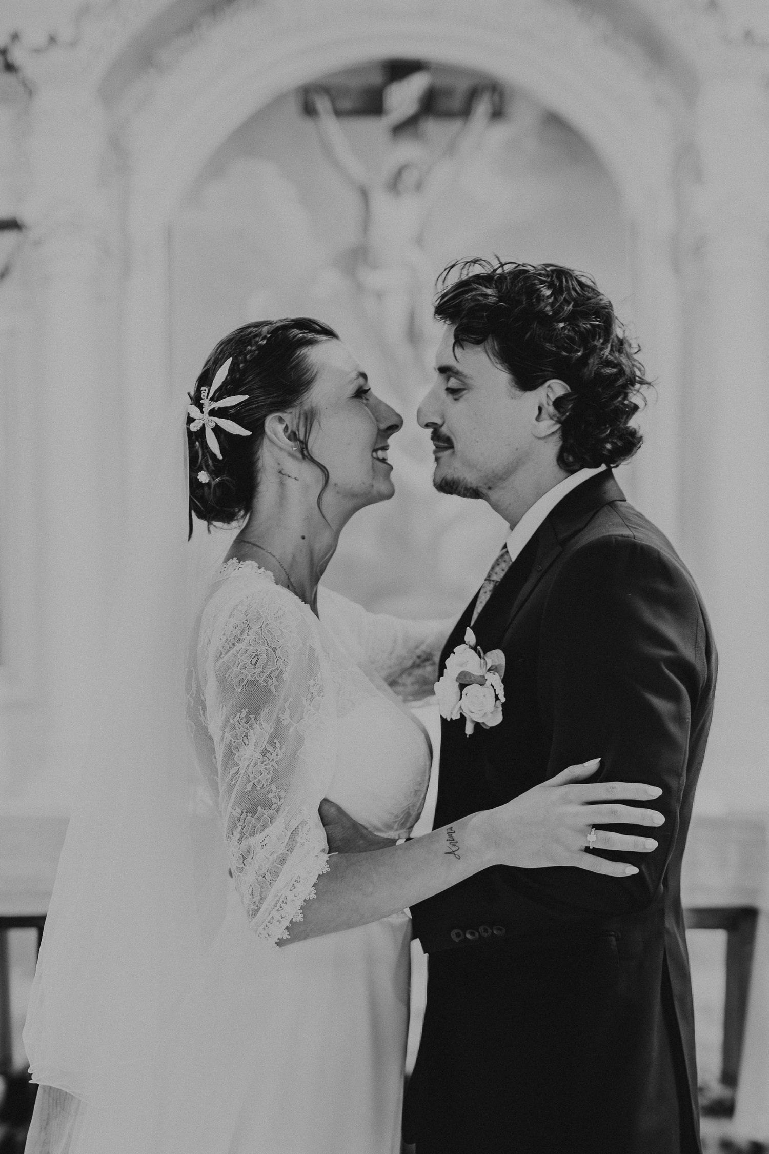 Black and white wedding photo sequence showing a bride and groom laughing and embracing in a romantic candid moment.