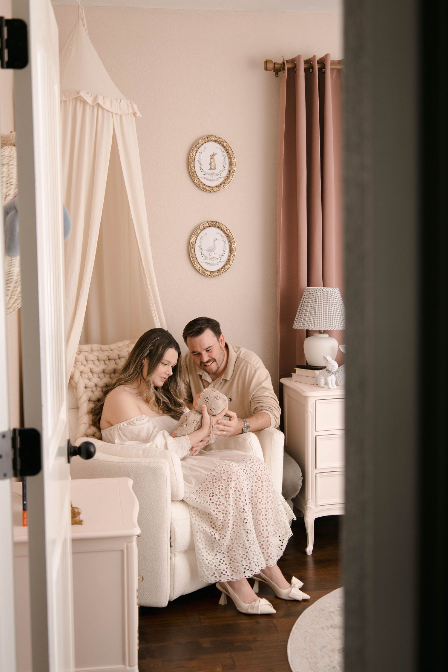 Intimate nursery moment in cream colored room with vintage decor.