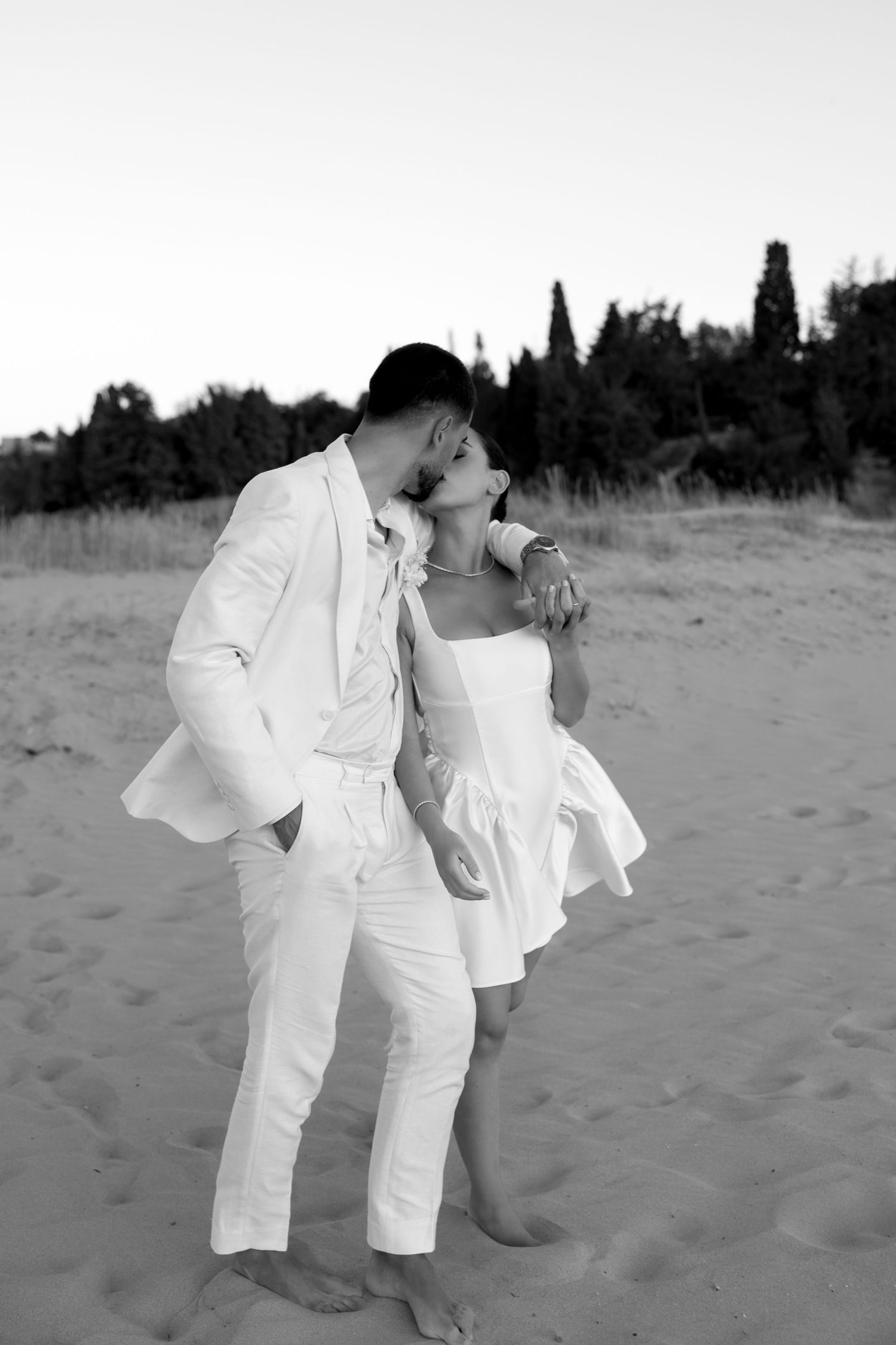 Wedding couple captured during photoshoot on scenic Praia da Agrinha coastline