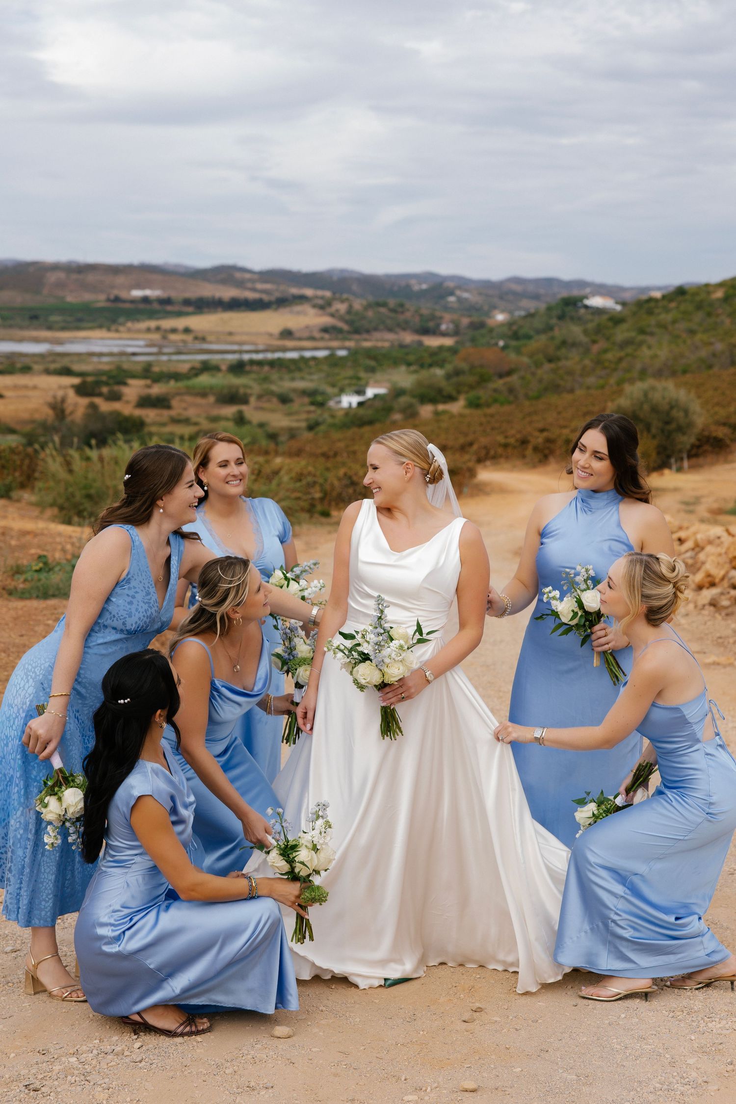 Fun and lively wedding photo of bride with her bridesmaids