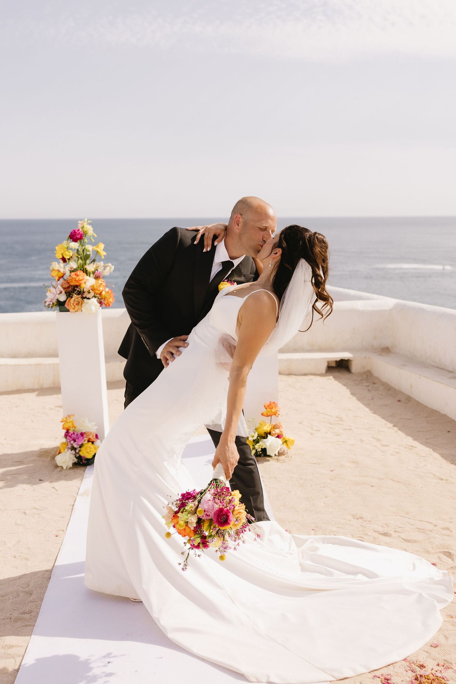 A wedding kiss captured on the scenic Nossa Senhora cliff with Portugal coastline in view