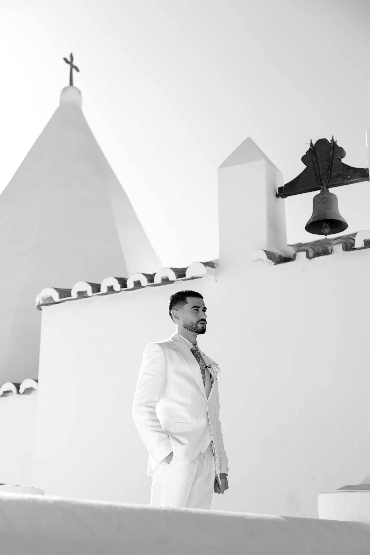 Groom standing next to the church of nossa senhora, algarve