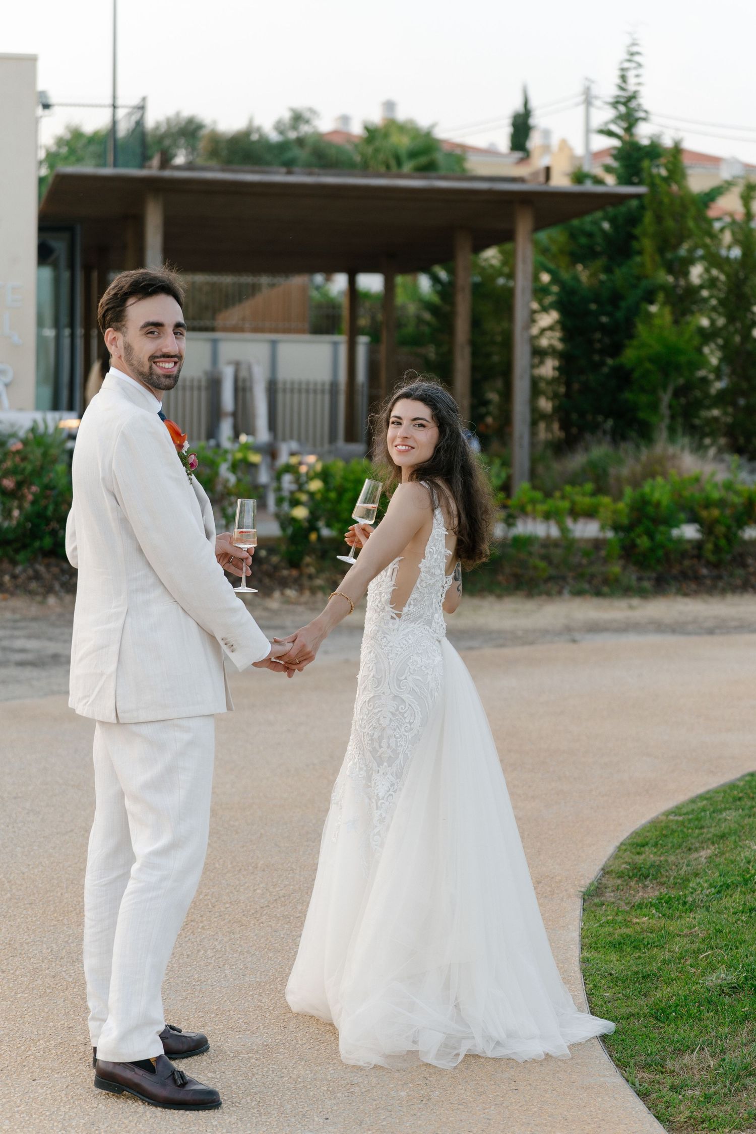 Bride and groom walking around at the white shell resort in the Algarve