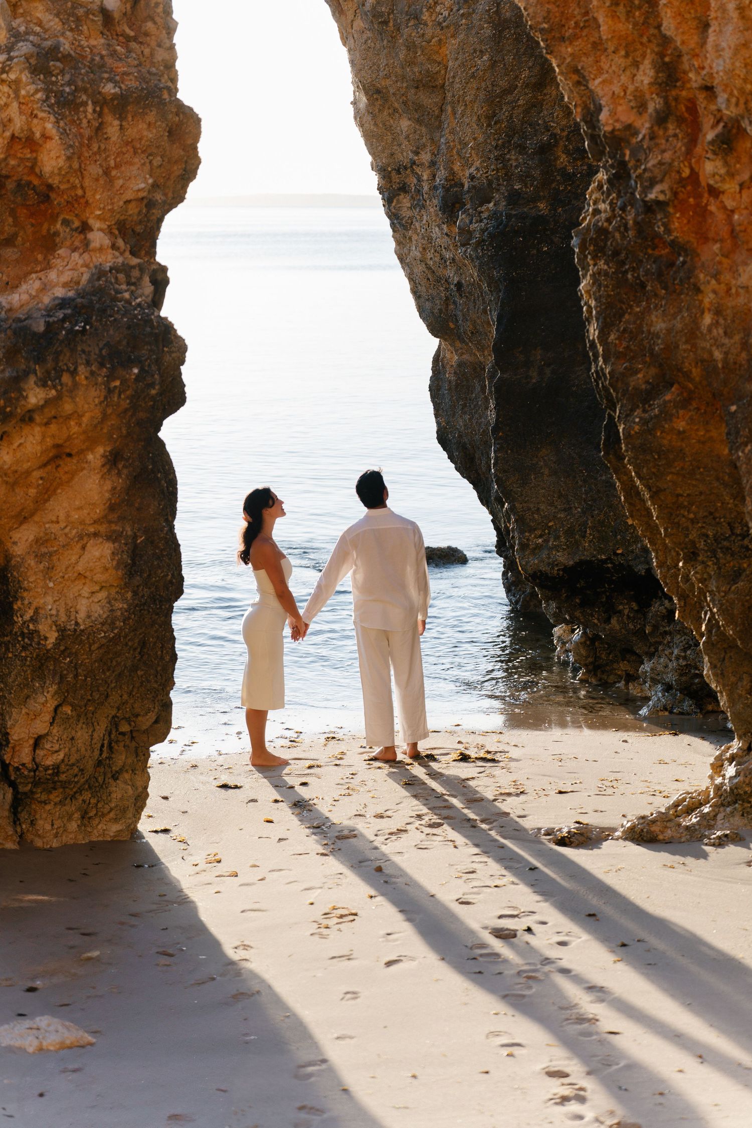 Couple photoshoot between the cliffs of Camilo Beach Lagos Portugal
