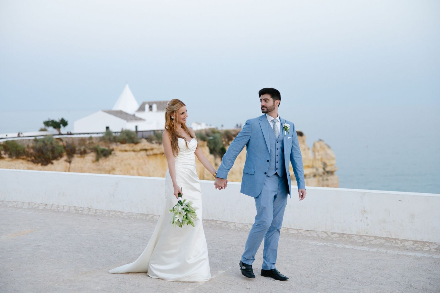 Wedding couple walking together at Nossa Senhora Algarve during their wedding at pestana viking resort
