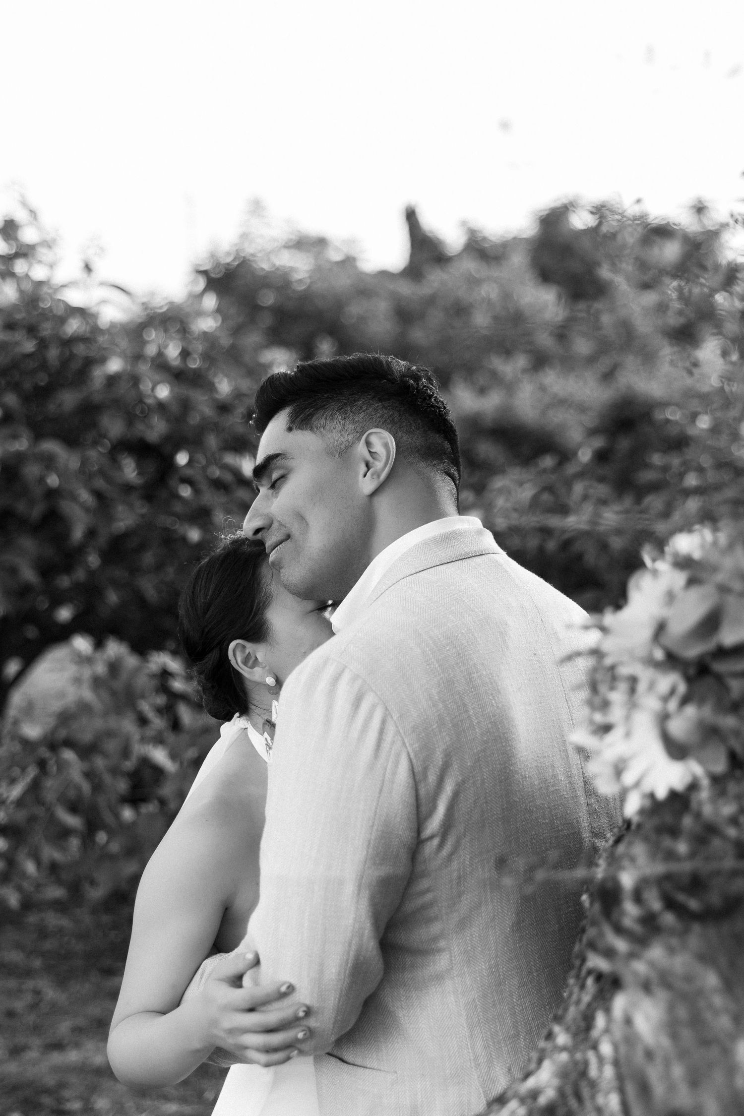 Bride and groom holding each other in the garden of Casa Manor Pedras de Cima