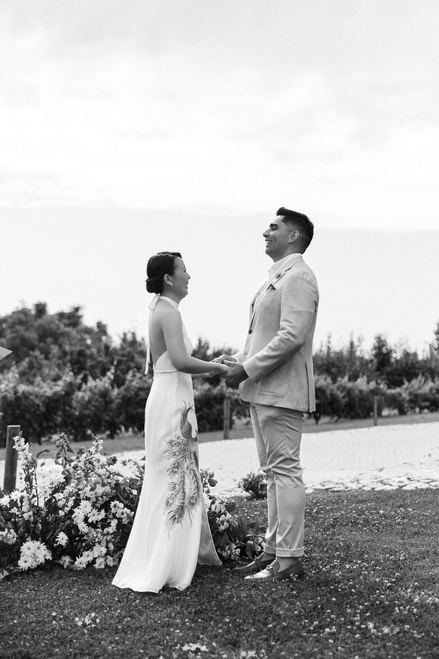Bridal couple standing on the aisle, holding hands