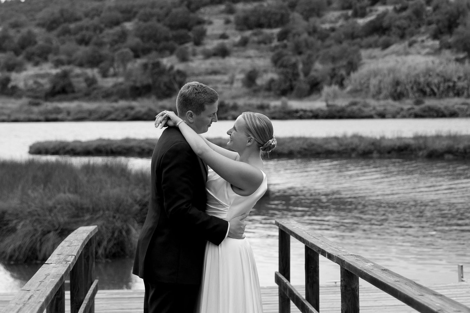 Romantic wedding of bride and groom by a serene lake in Portugal