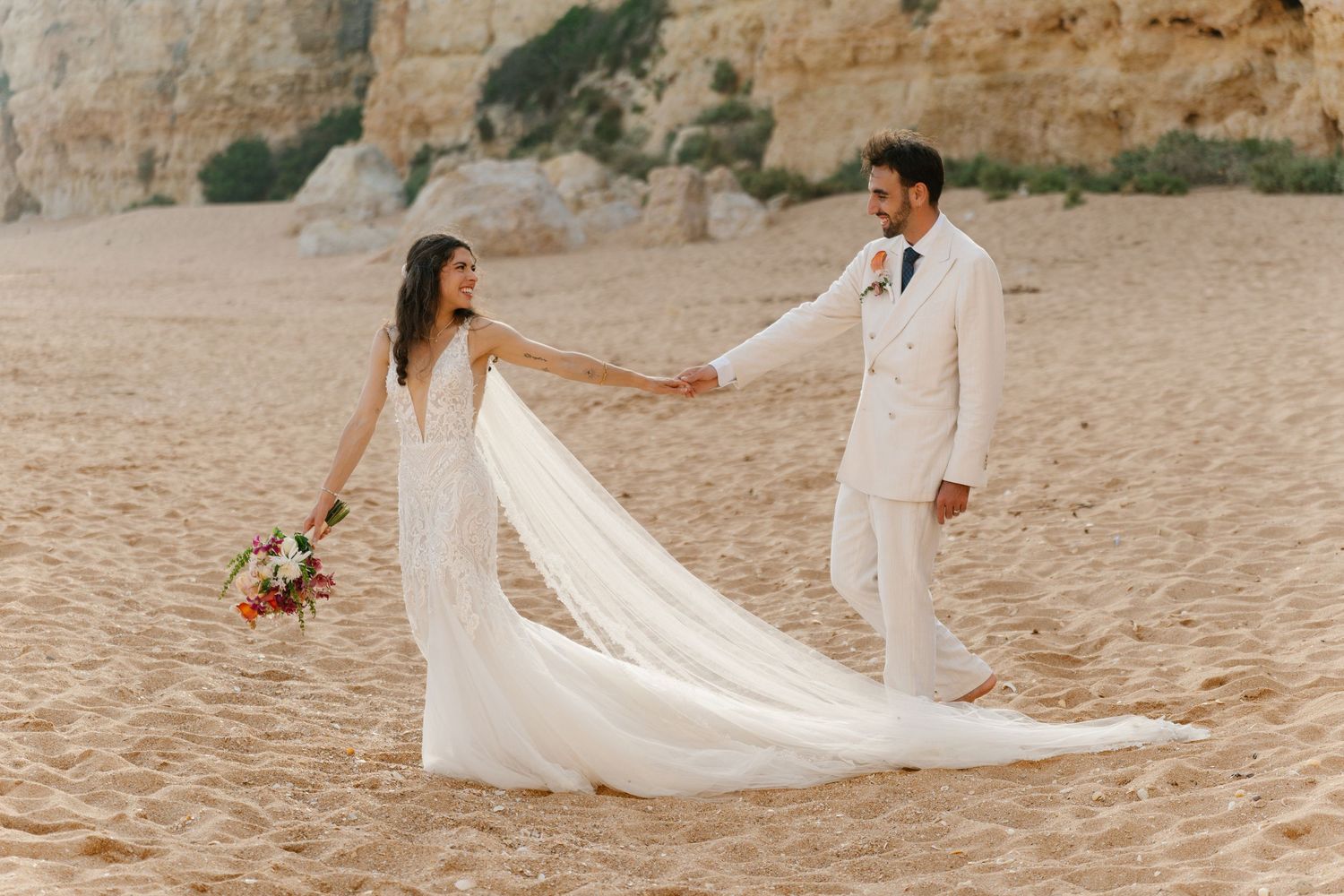 Bride and groom walking on the beach of Nossa Senhora