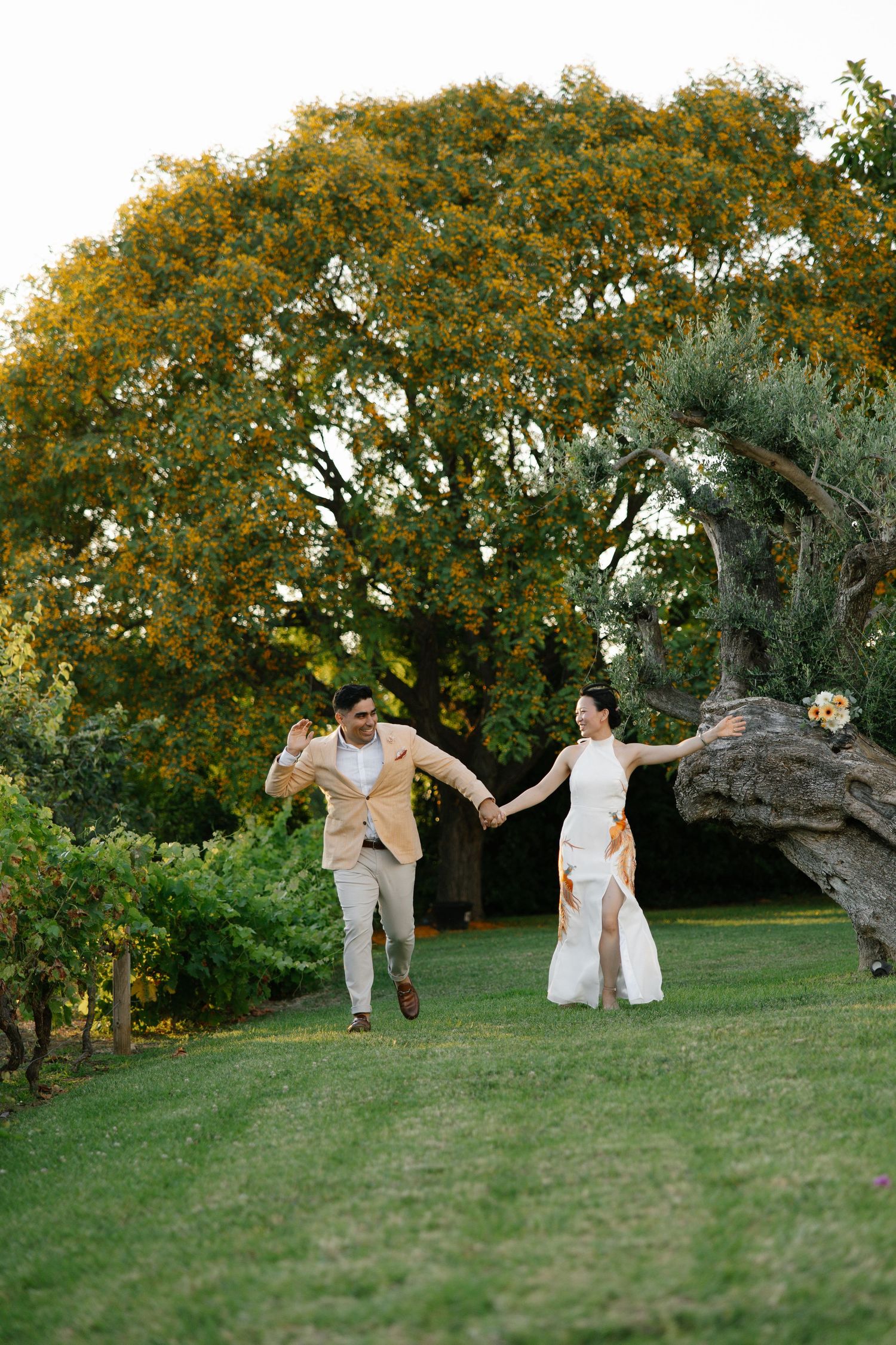 Bridal couple running together in the garden of Casa Manor Pedras de Cima in Tavira