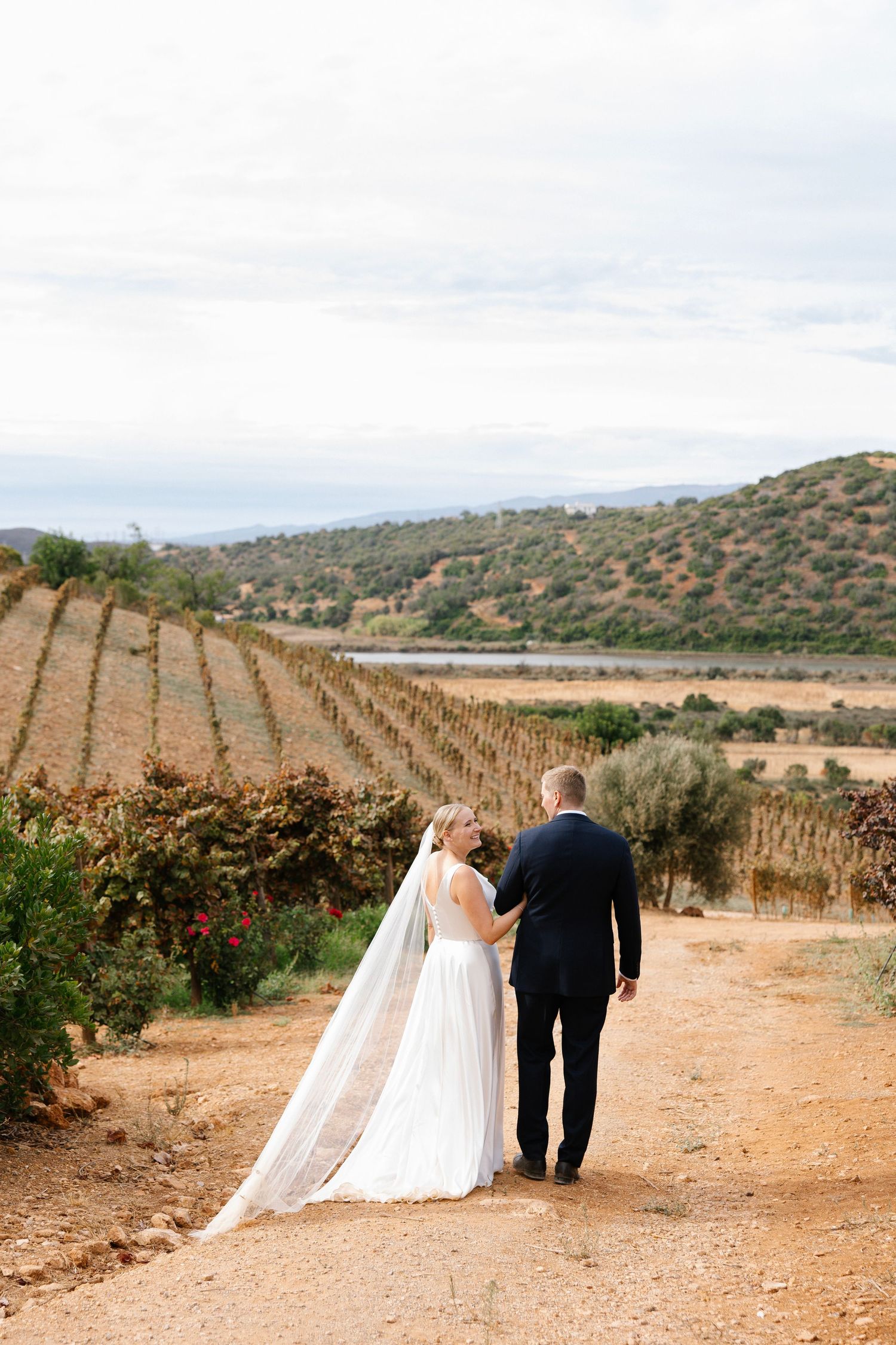 Wedding couple walking together between wineyard of the Arvad winery in Algarve, Portugal