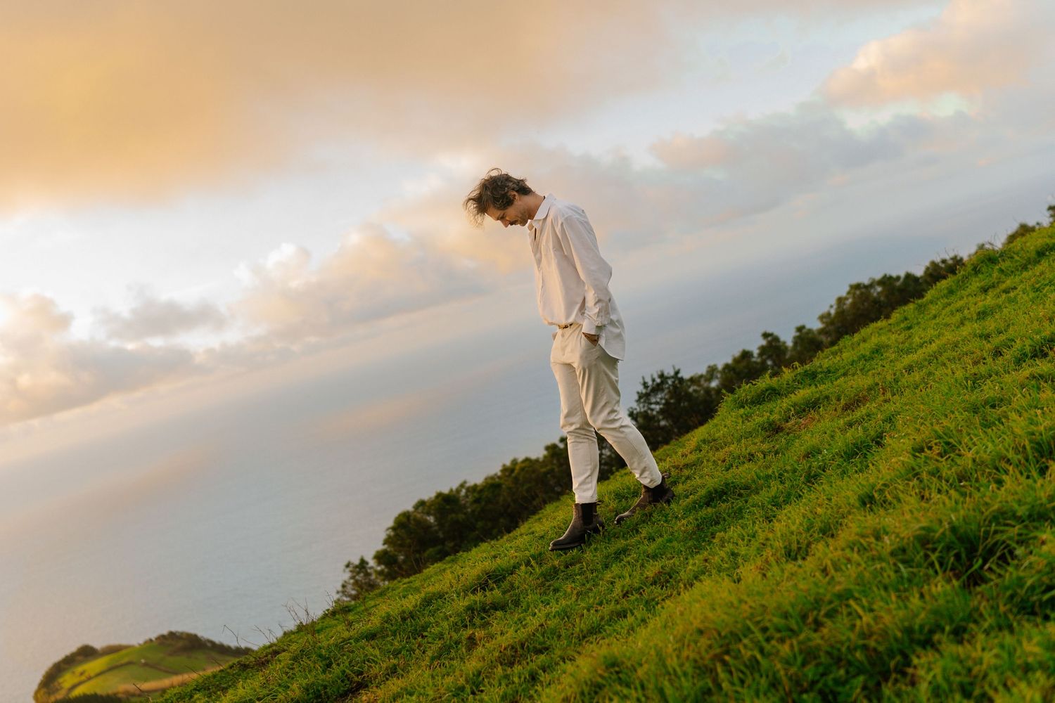 Sunrise over lush green hills with morning mist in the Azores