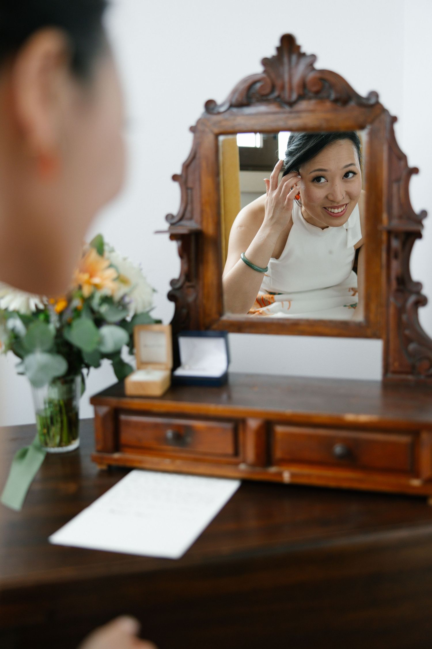 Bride looking in the mirror during her getting ready