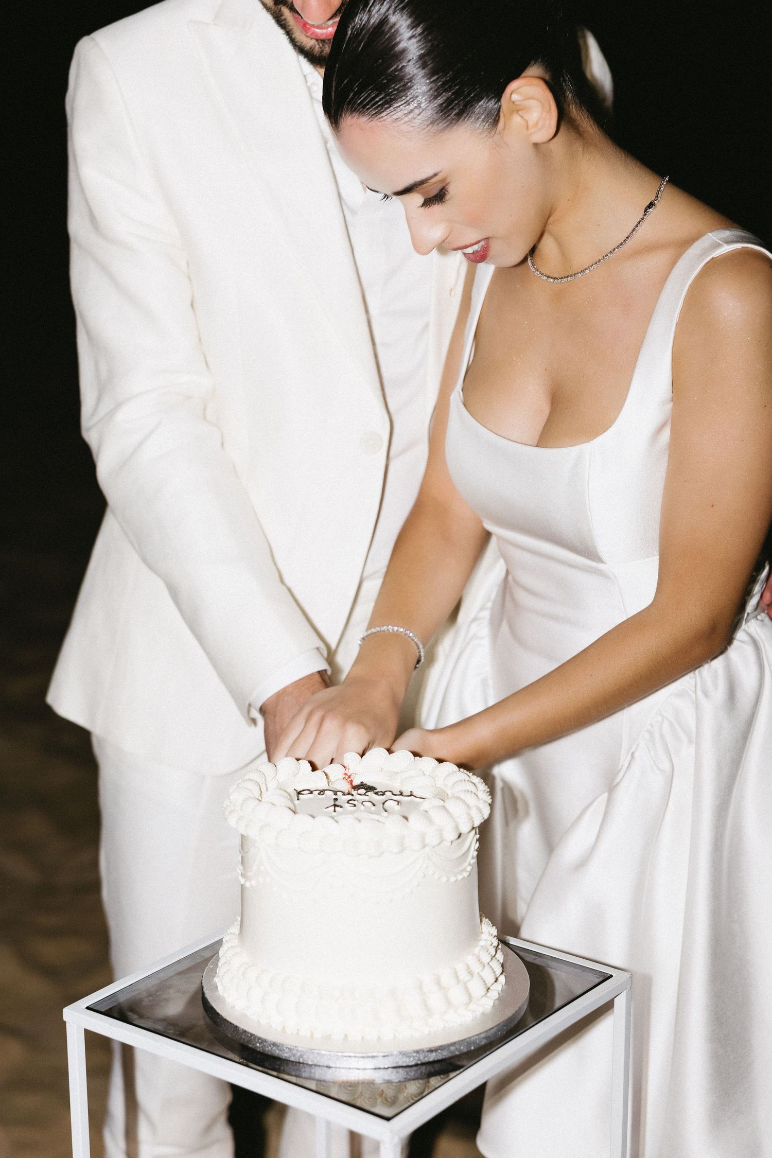 Wedding couple sharing the cake cutting moment at their celebration