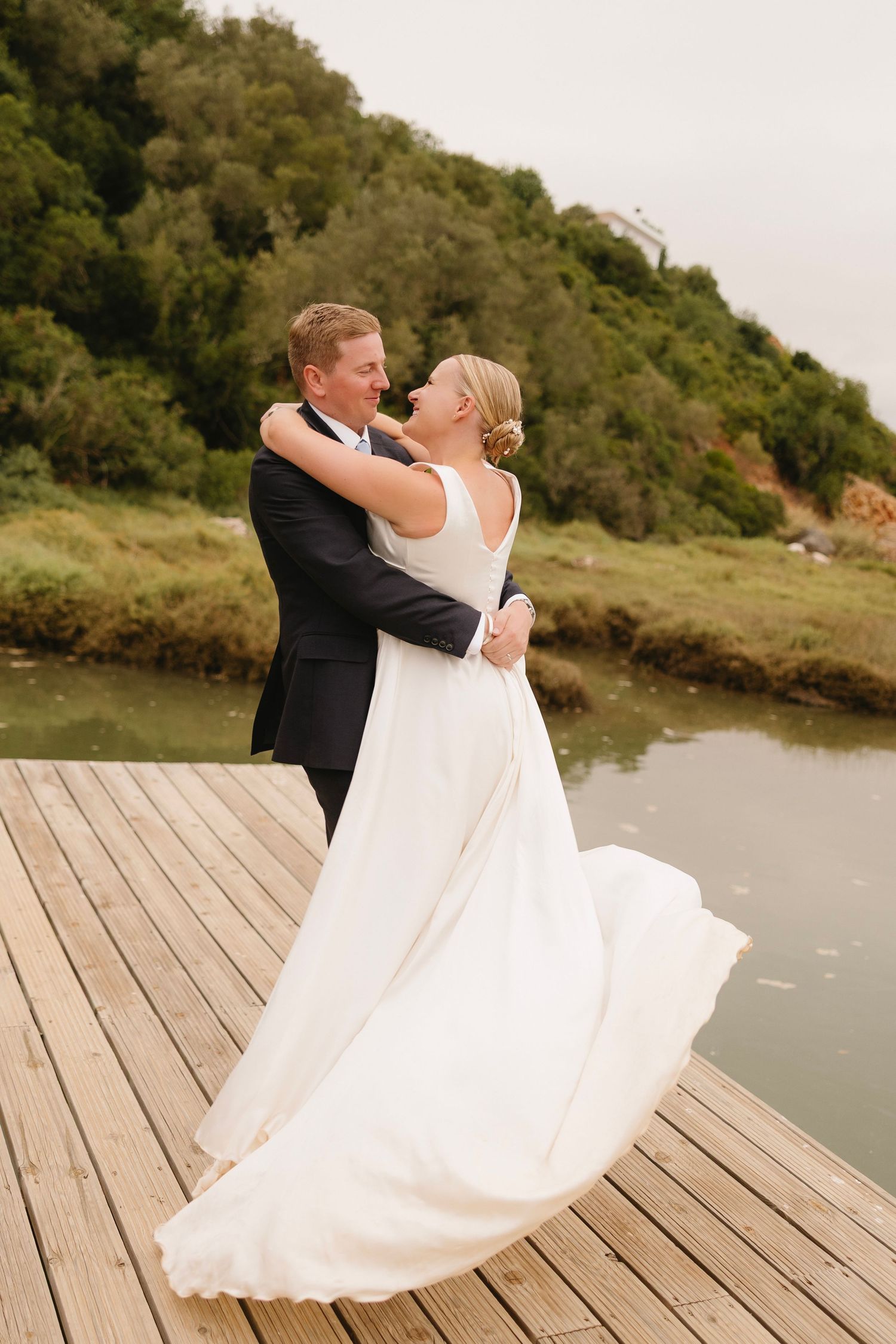 Romantic moment of groom swirling bride during wedding photoshoot