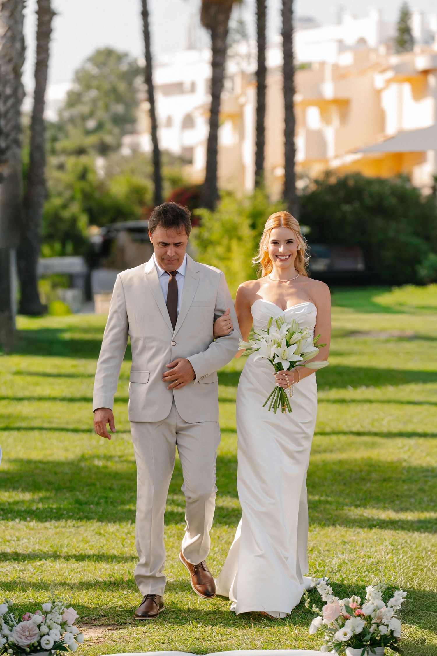 Bride coming to the aisle accompanied with her father during a wedding in the pestana viking resort, porches