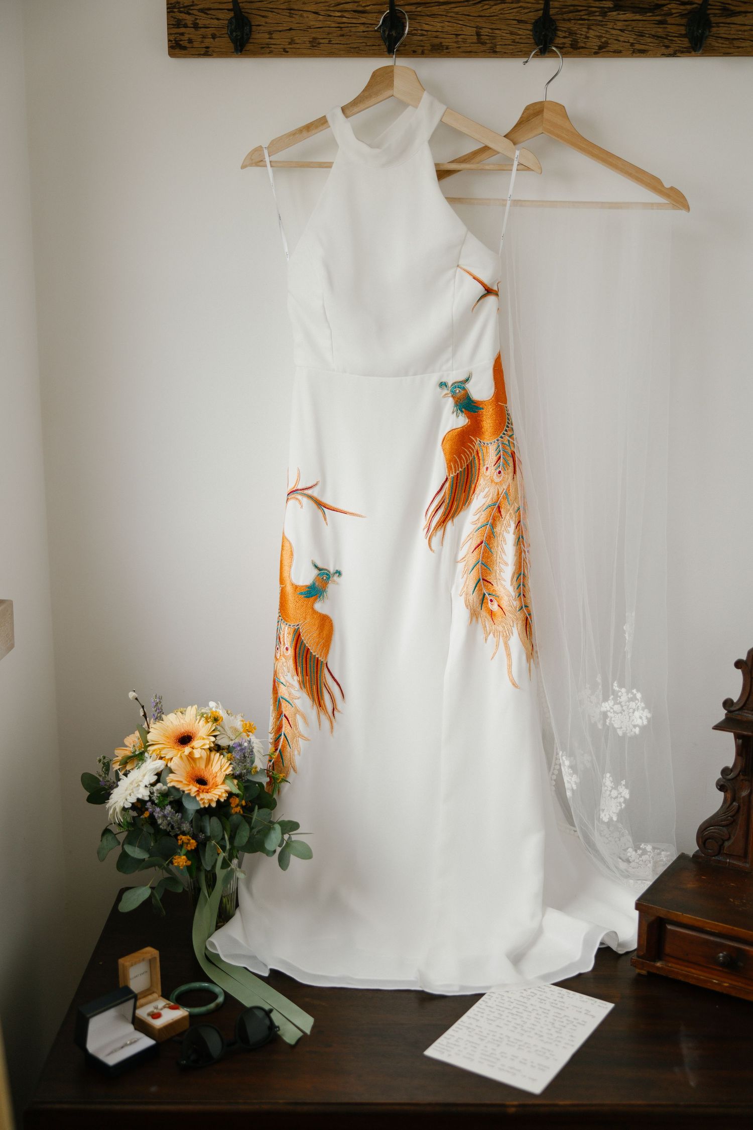 The creative wedding dress of the bride hanging in the room before the ceremony