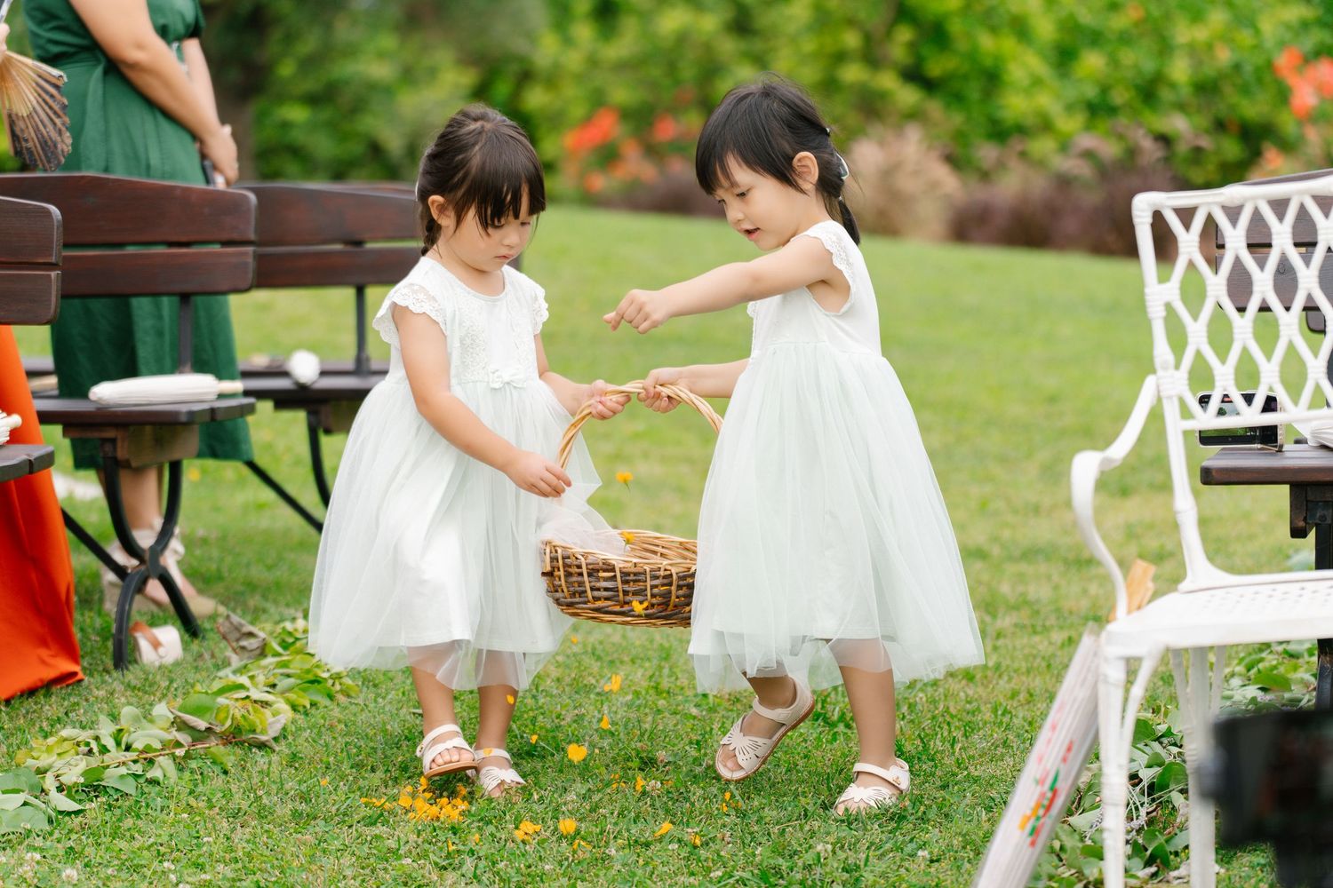 Children scattering flowers on the wedding aisle creating a beautiful path for the couple