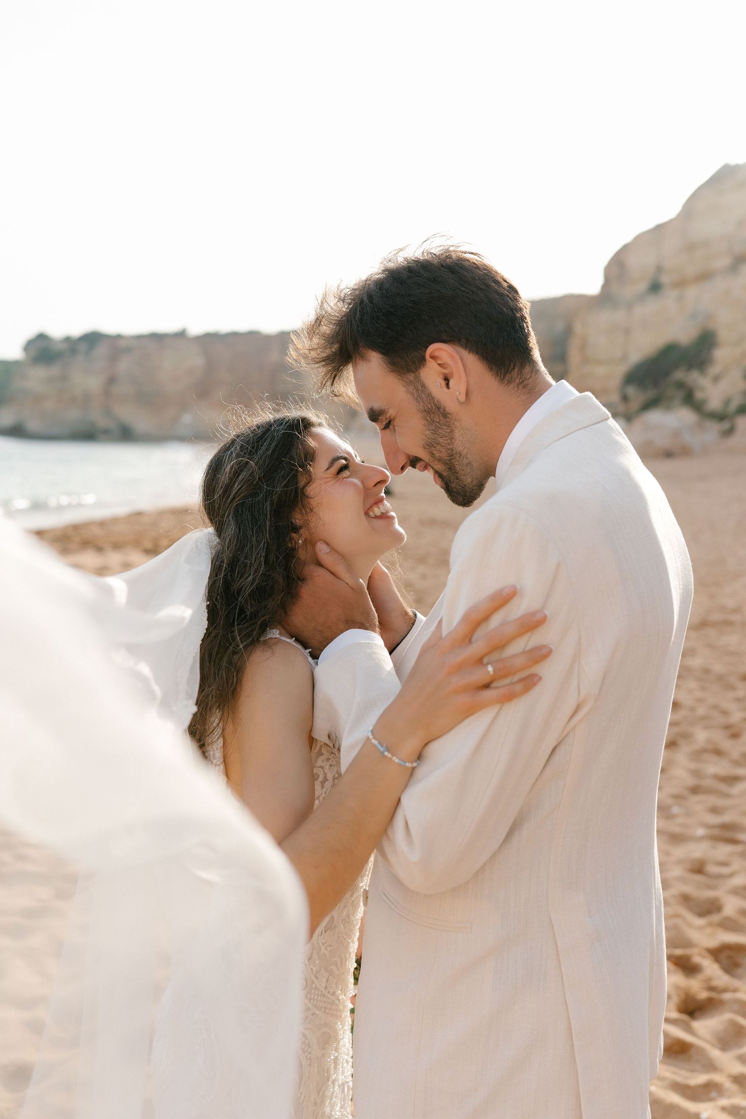 Couple standing on the beach of Nossa Senhora Beach in the Algarve, Portugal