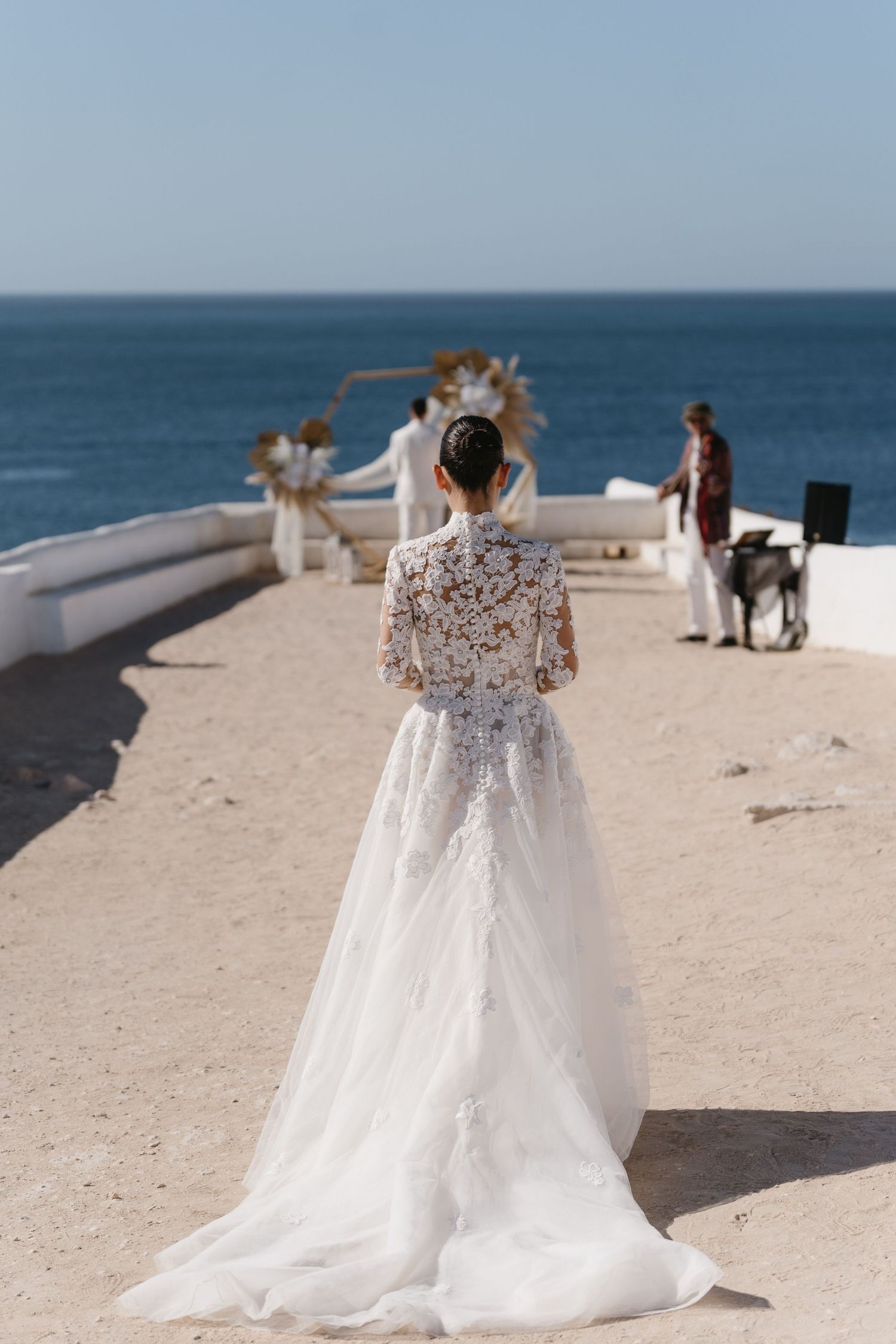 bride walking to the groom at their first look on the cliff of nossa senhora da rocha, porches, portugal