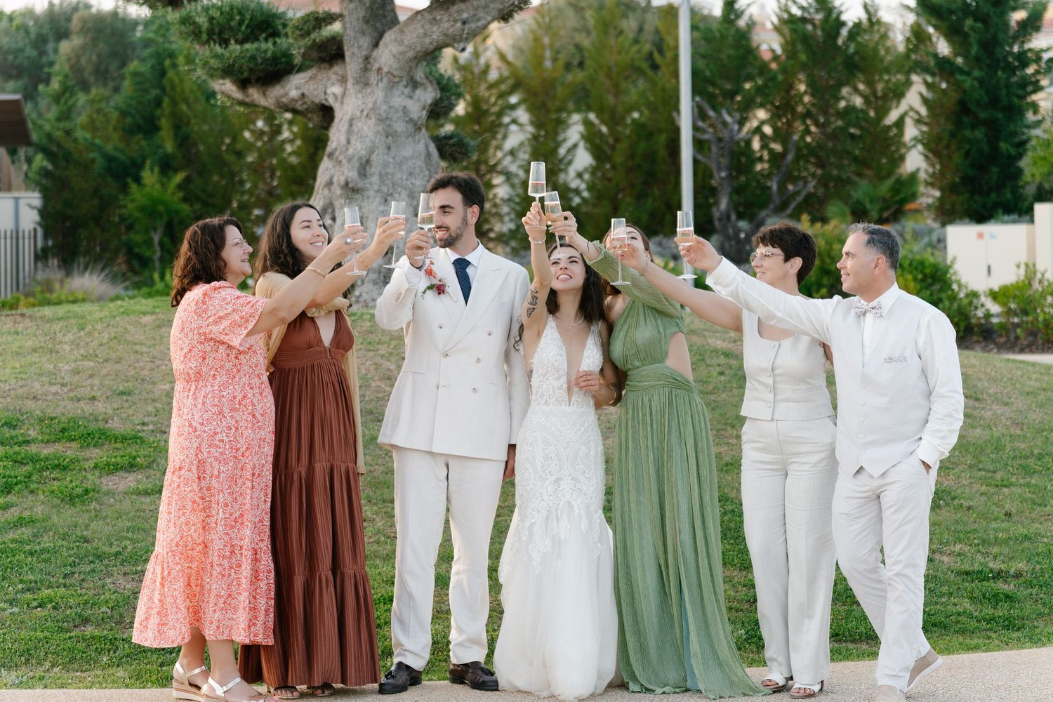 Friends and family cheering champagne together in the white shell resort, Porches