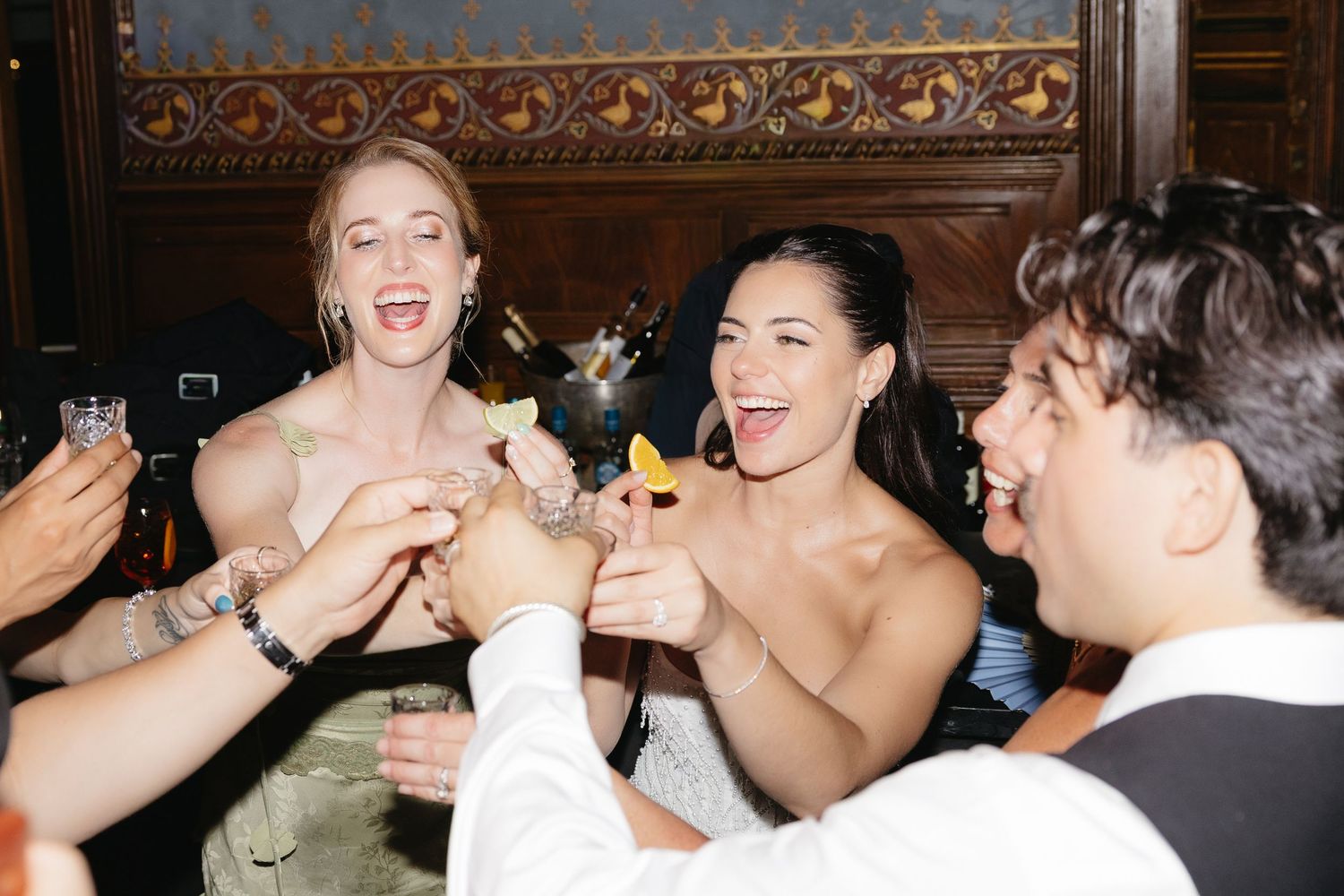 Group of friends toasting with cocktails and sparklers at a lively celebration party.