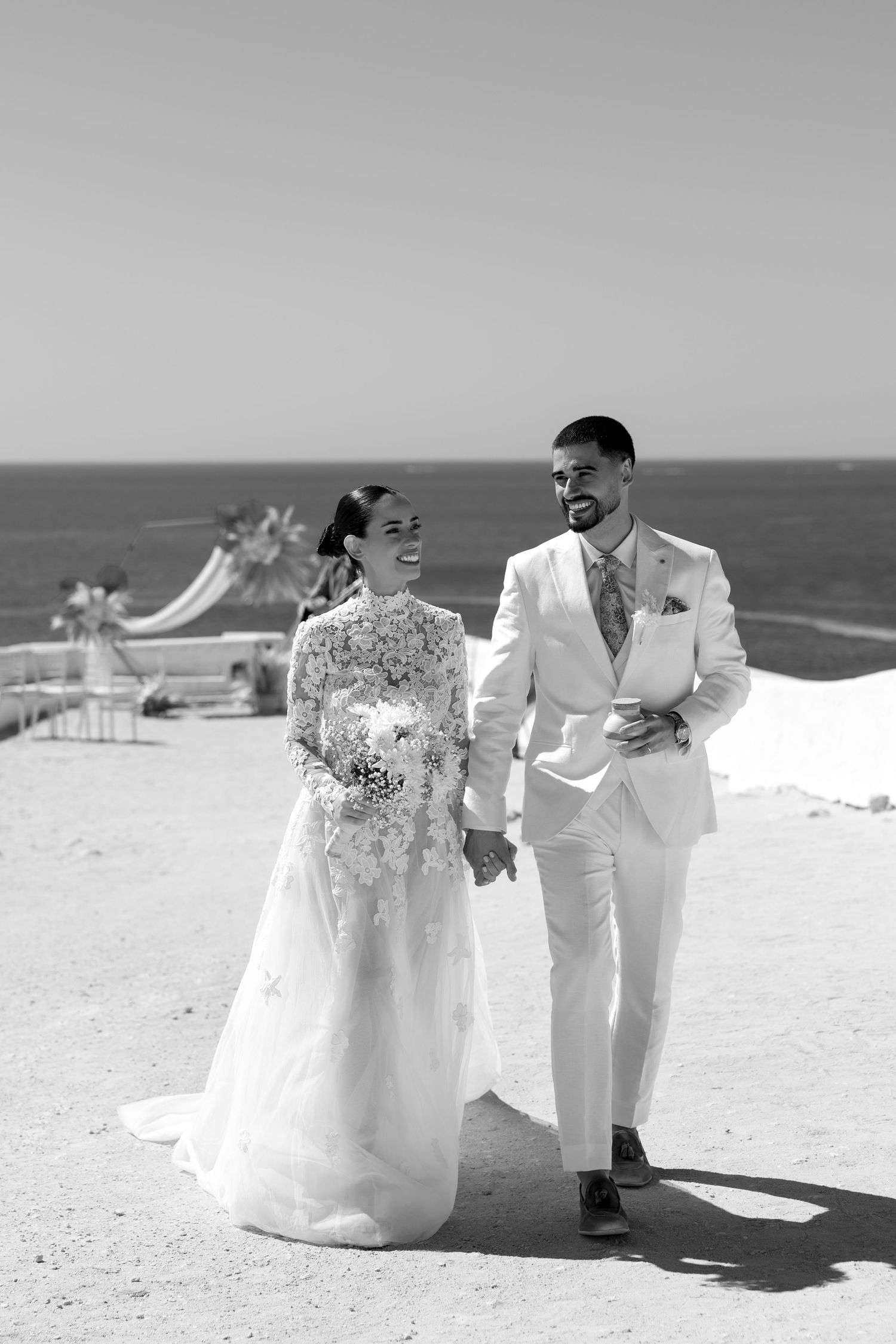 bridal couple walking together on the cliffs of nossa senhora, algarve