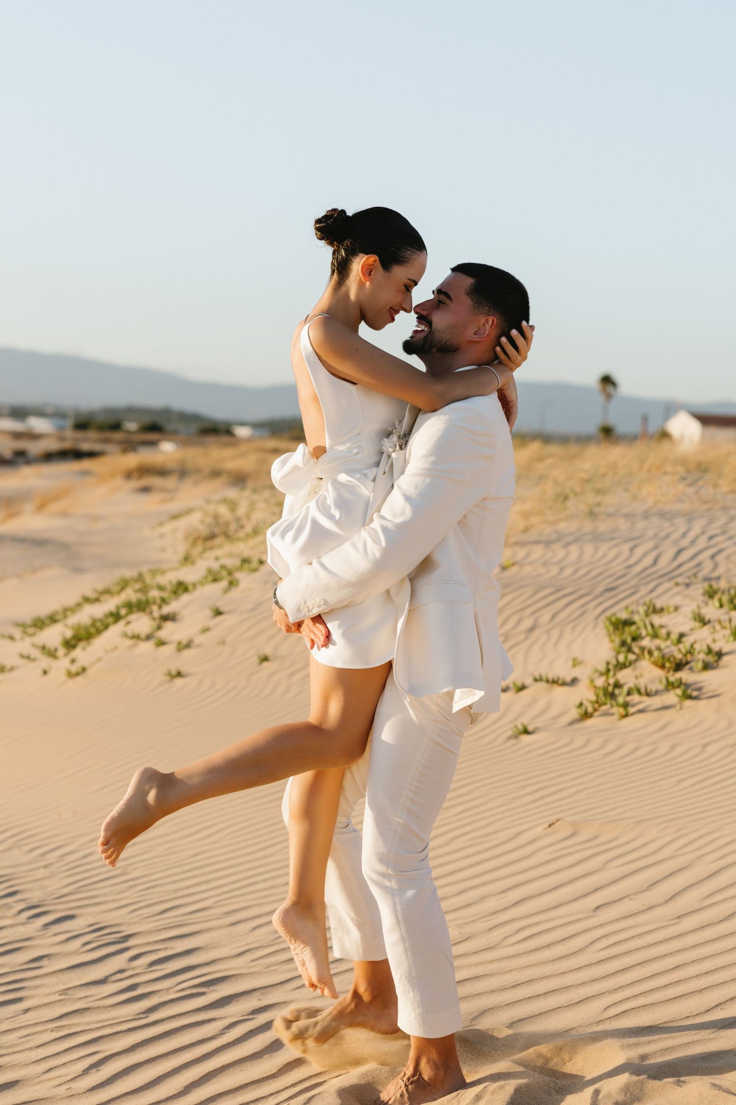 Groom lift up the bride at praia da angrinha, Algarve