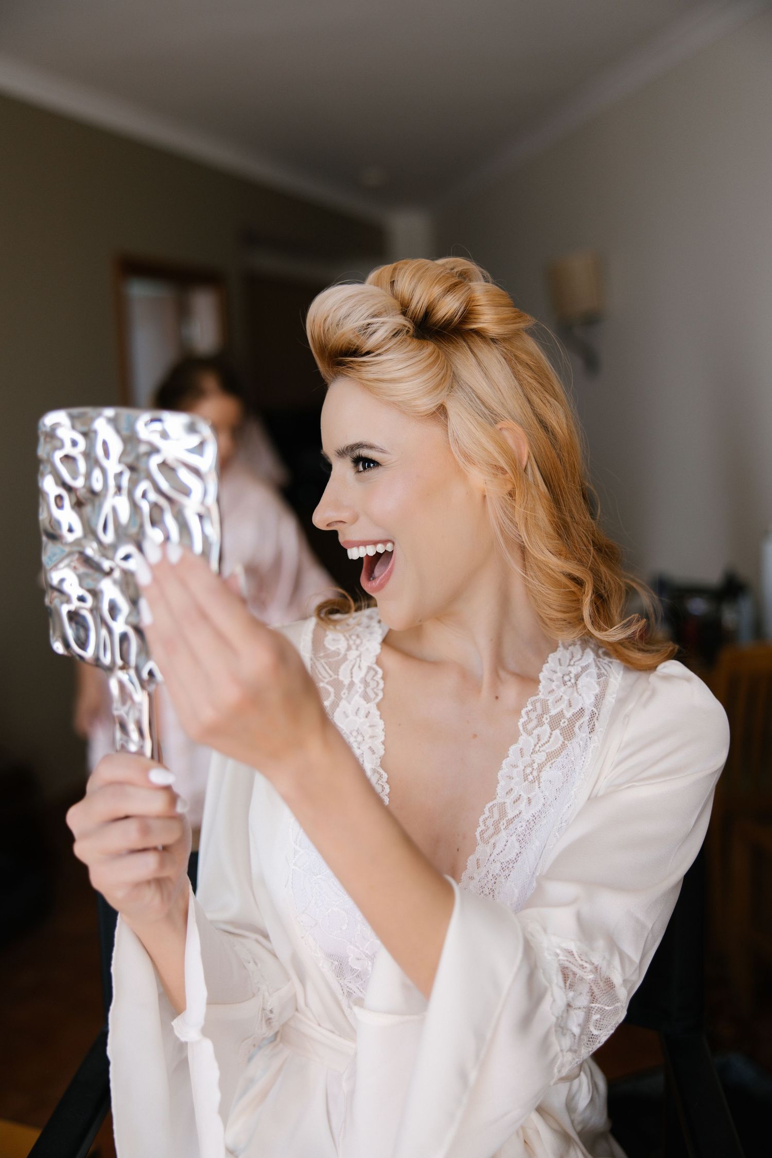 Bride looks in the mirror to see her hair