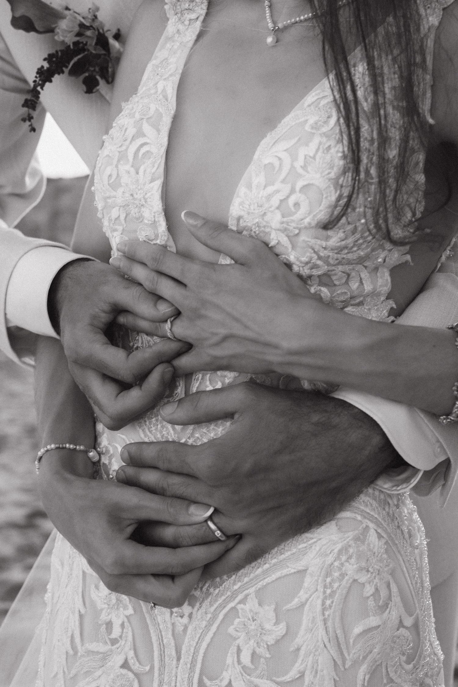 Couple holding hands together with the rings