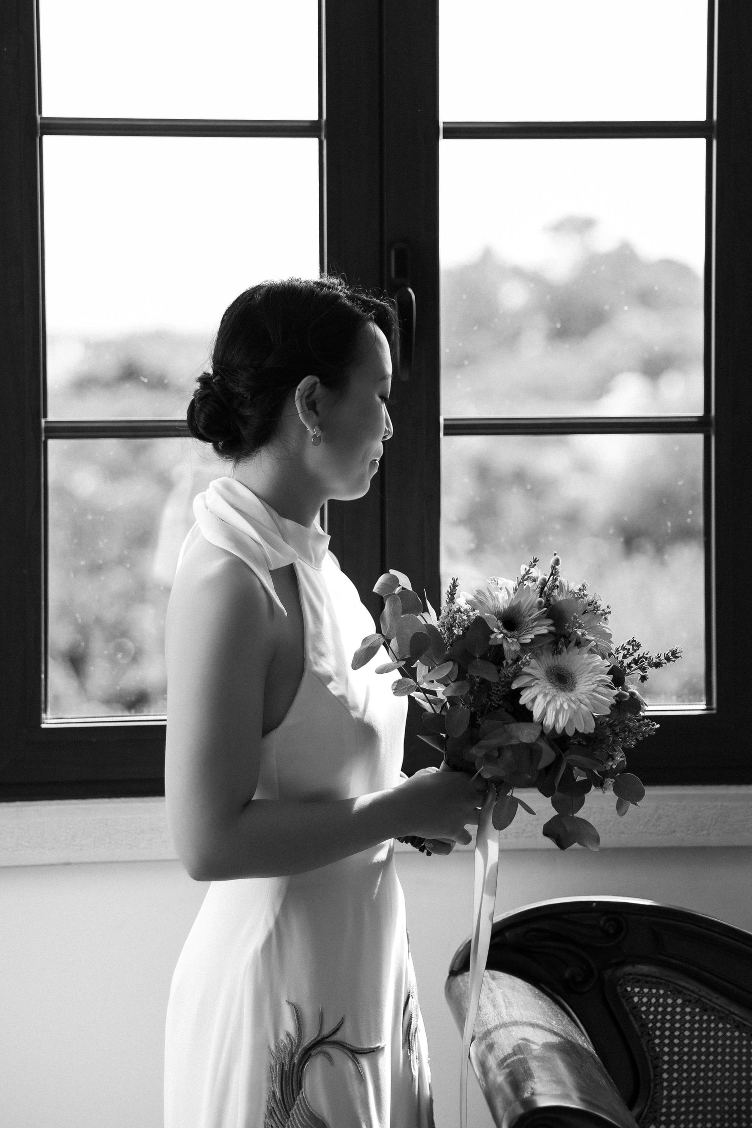 Bride looking through the window during her getting ready moment at the wedding in the Algarve