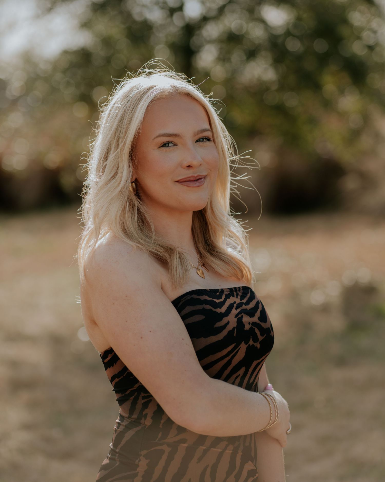 Portrait in warm autumn lighting outdoors with natural backdrop.