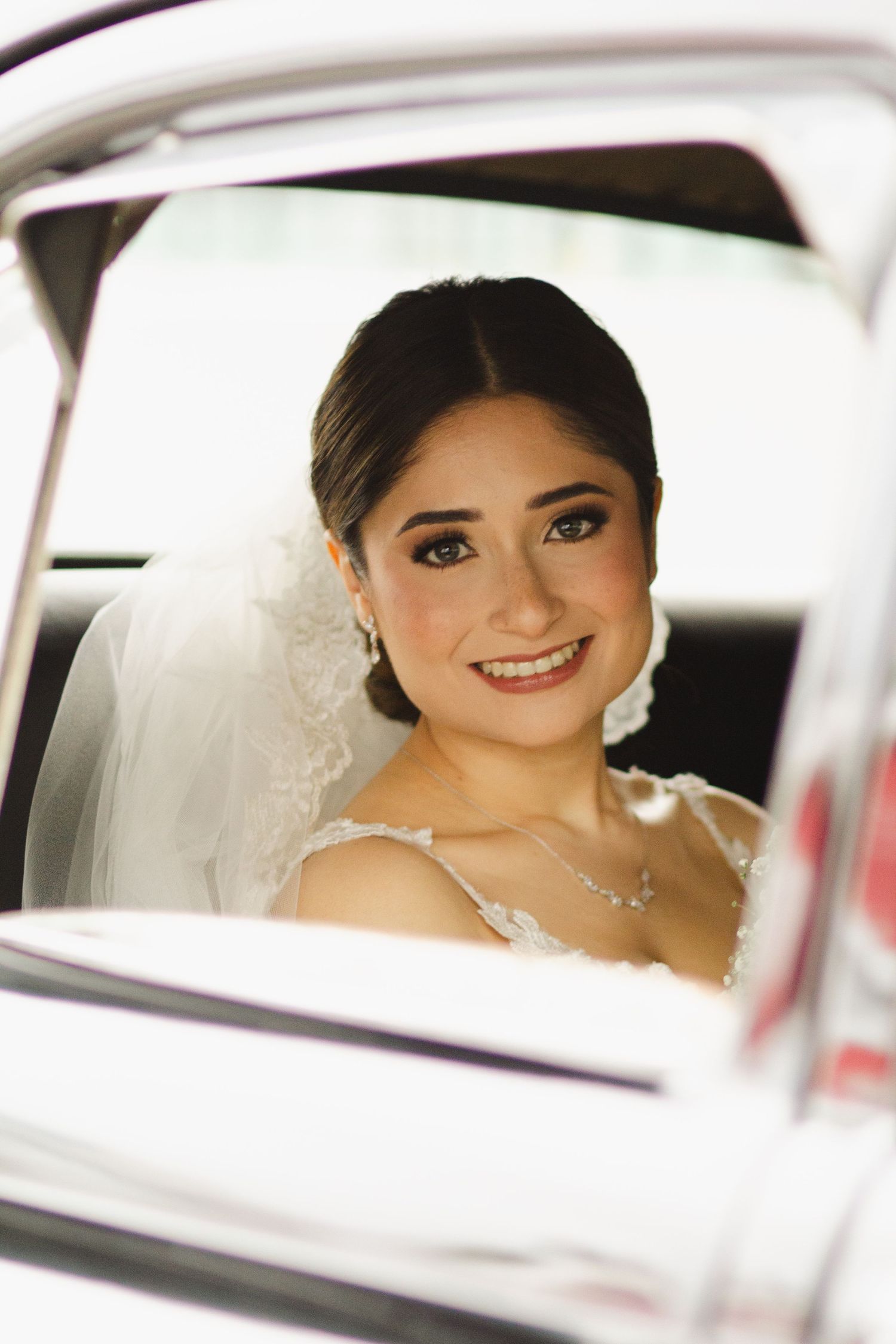 Classic bridal portrait through a vintage car window.