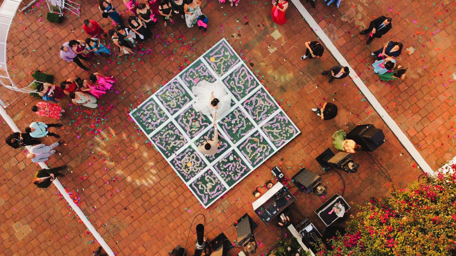 Aerial view of people playing games on a large painted concrete surface with colorful designs and patterns.