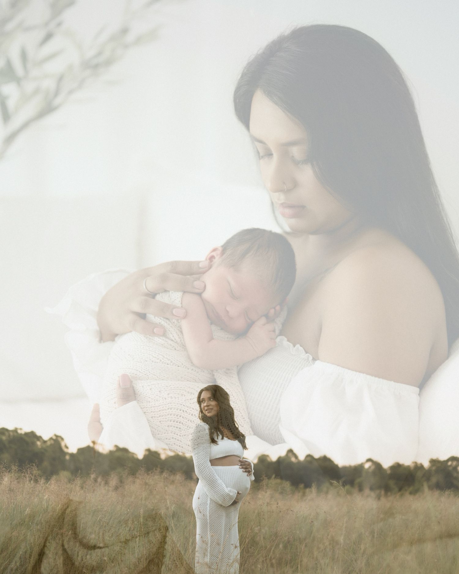 Mother holding newborn baby in her arms outdoors in soft, natural light