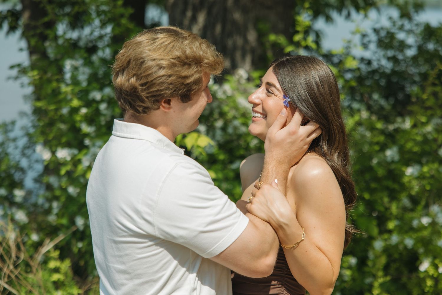 Couple sharing a joyful moment together outdoors with the man holding her face.