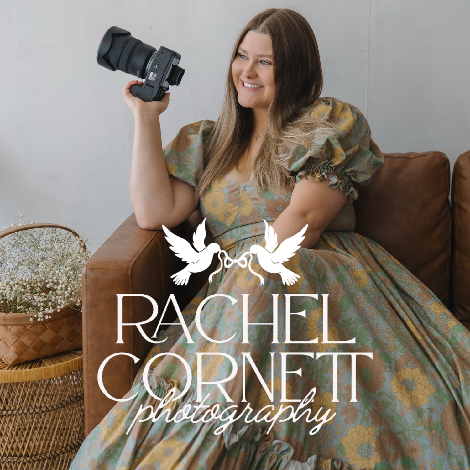 Rachel Cornett Photography logo with smiling female photographer holding a camera while seated on a leather sofa.
