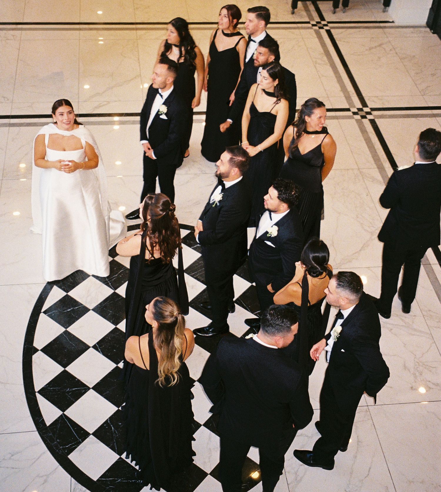 Bride and groom wrangle the bridal party and groomsmen for group photos.