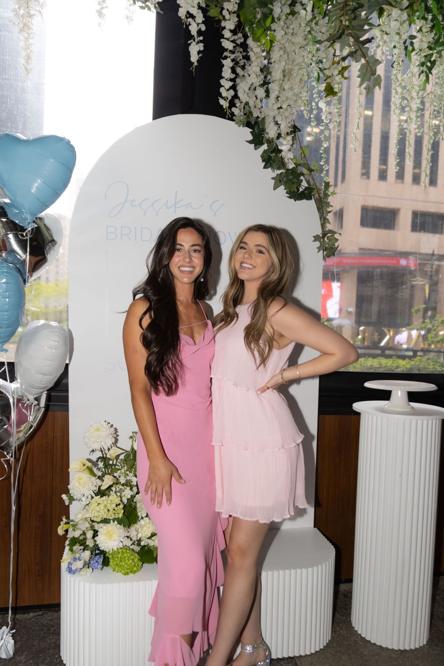 Group photo of two guests at bridal shower. Both women are wearing all pink.