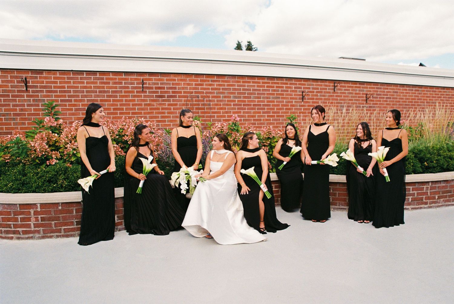 Bride and bridal party posing together in a rooftop garden of the Royal Venetian Mansion in Vaughan, Ontario.