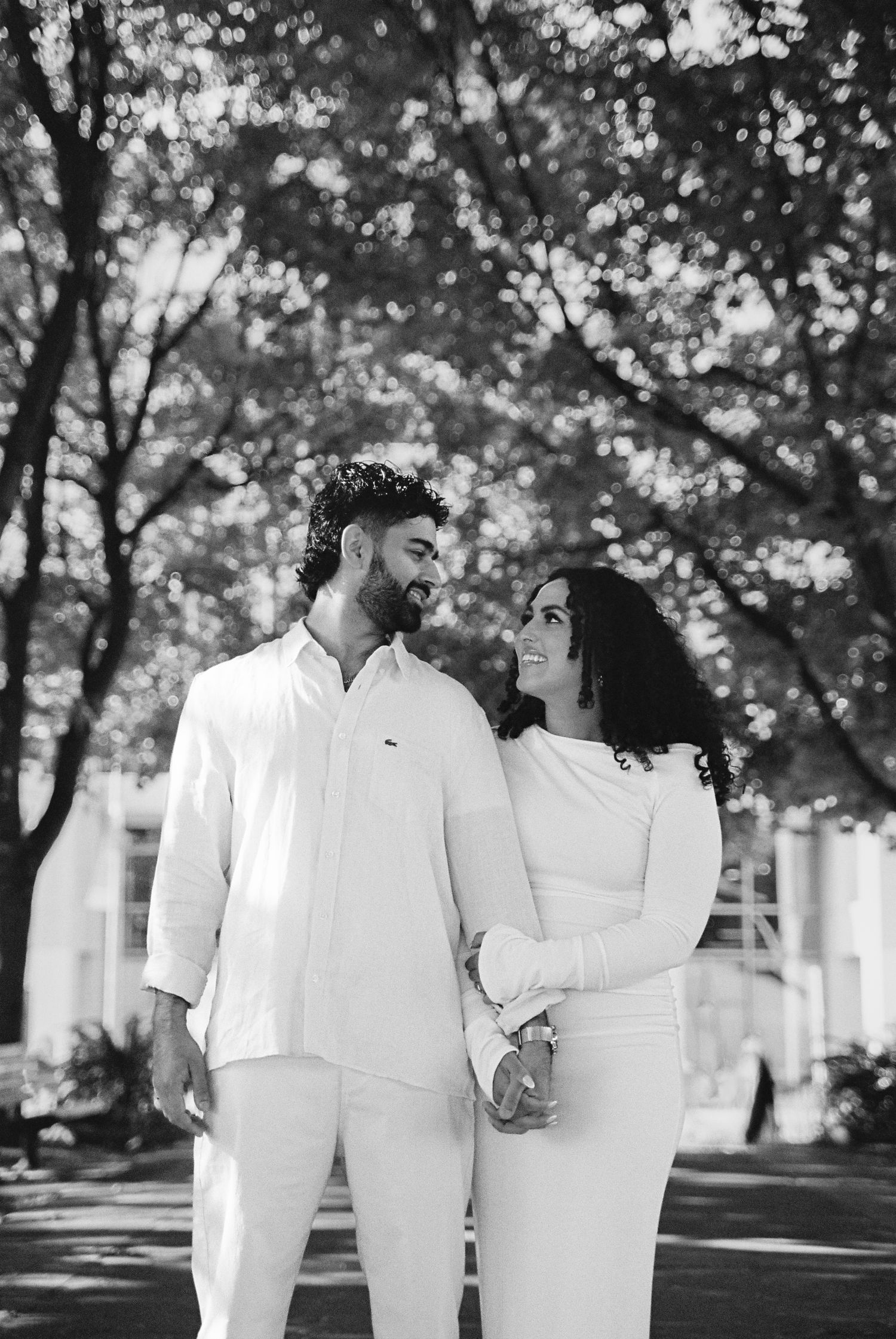 Fiancés standing in the Toronto Music Gardens together for their engagement photos.
