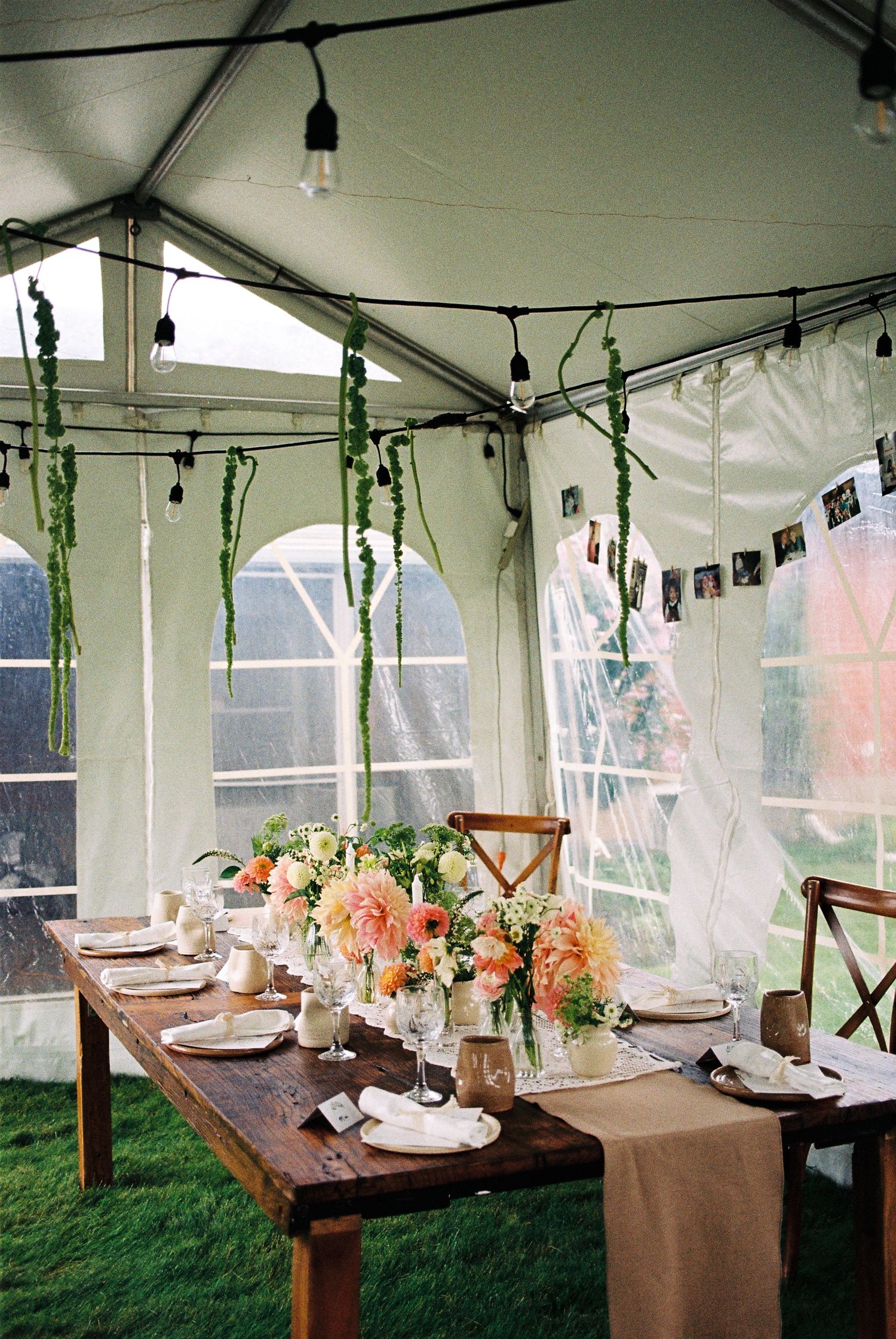 Elopement back yard reception in an outdoor canopy tent with a wooden dining table captured on 35mm film.