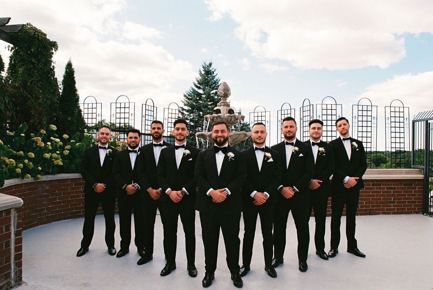Groom and groomsmen posed together for a group photo on the rooftop of the Royal Venetian Mansion in Vaughan.